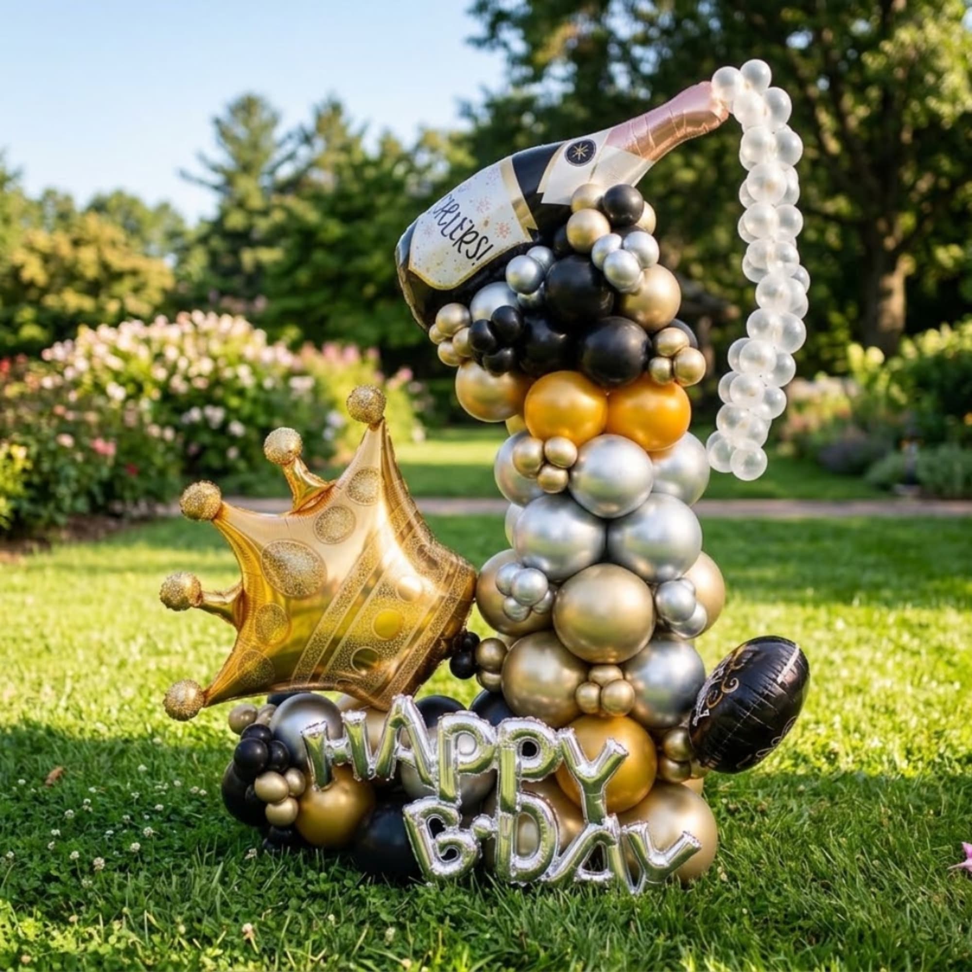 Birthday balloon sculpture with a crown and champagne bottle shape