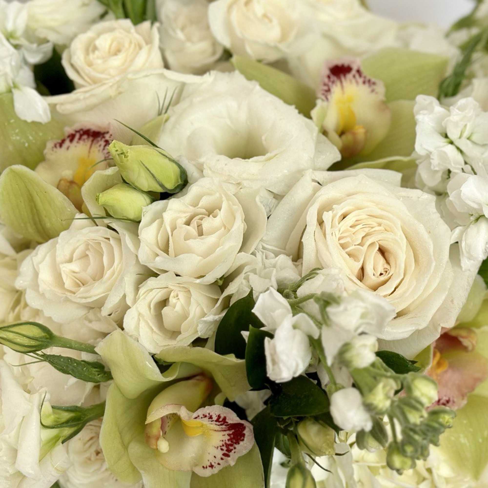 Cream and white bouquet with roses and pale green calla lilies