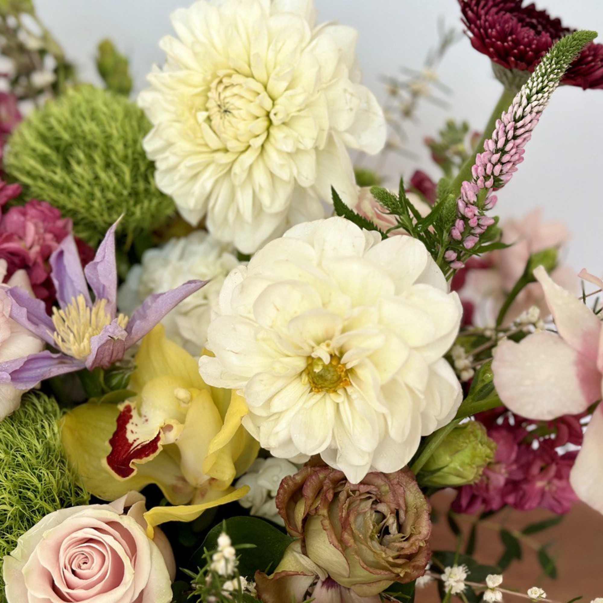 Mixed bouquet with cream, pink, yellow, and purple flowers
