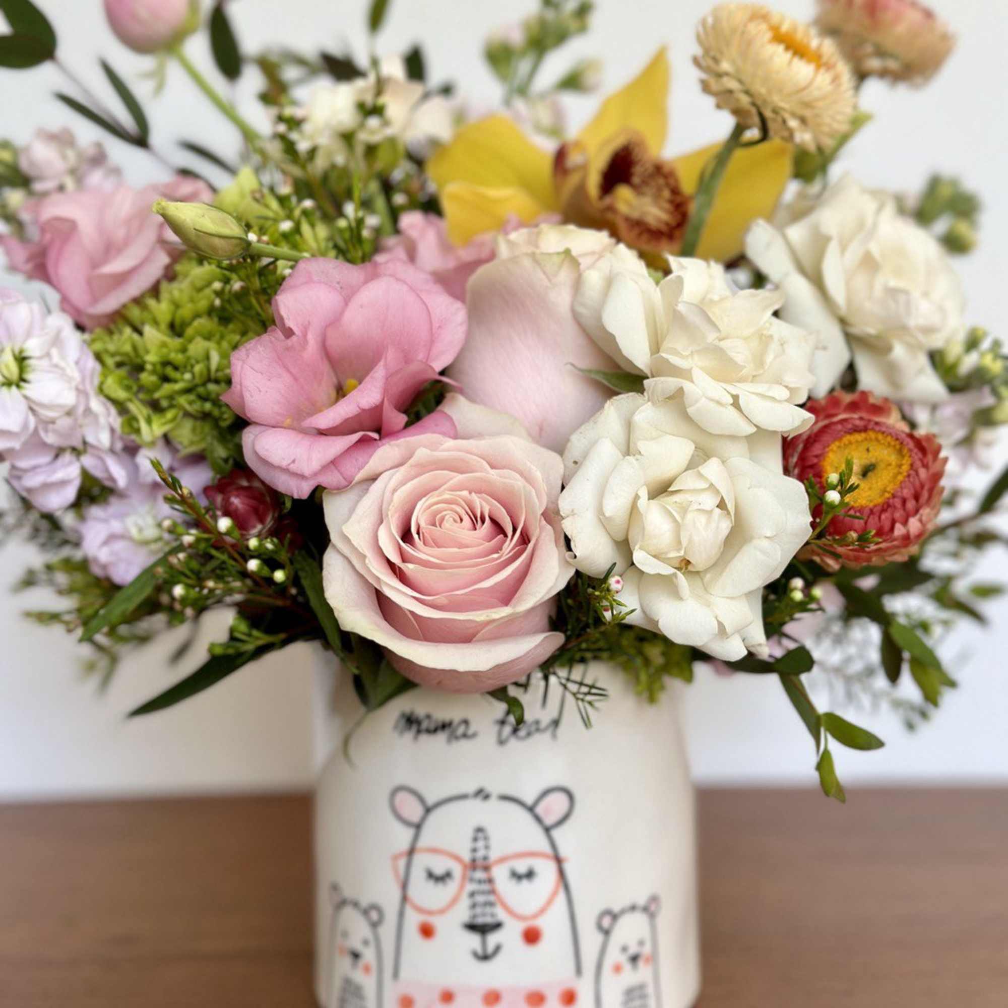 Pink and white mixed bouquet in a decorated ceramic vase