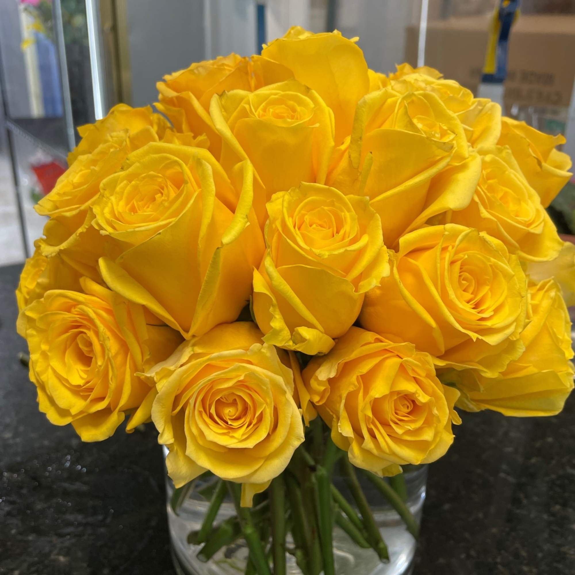Bouquet of yellow roses in a clear glass vase