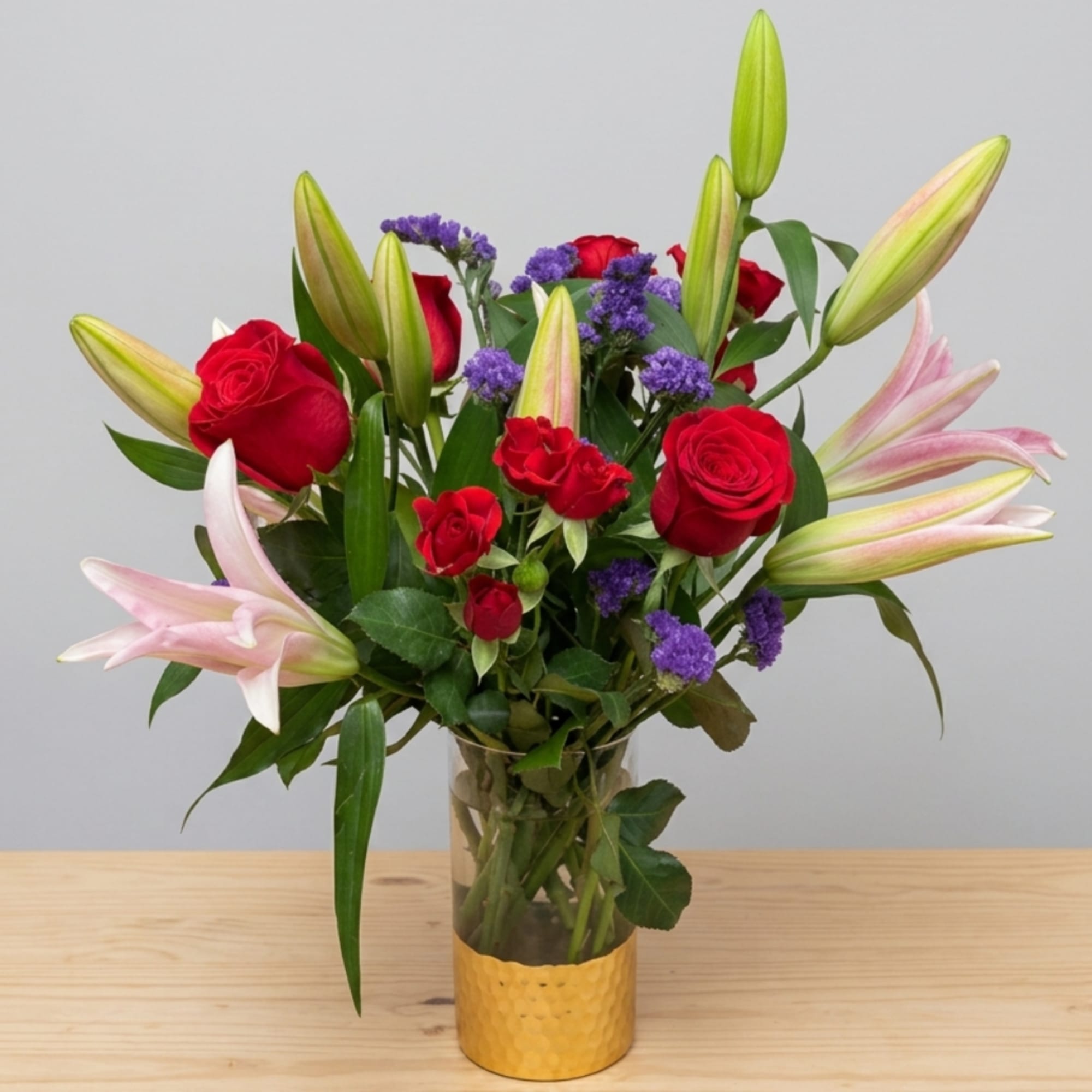 Bouquet of red roses and pink lilies in a glass vase, photo 3 of 3