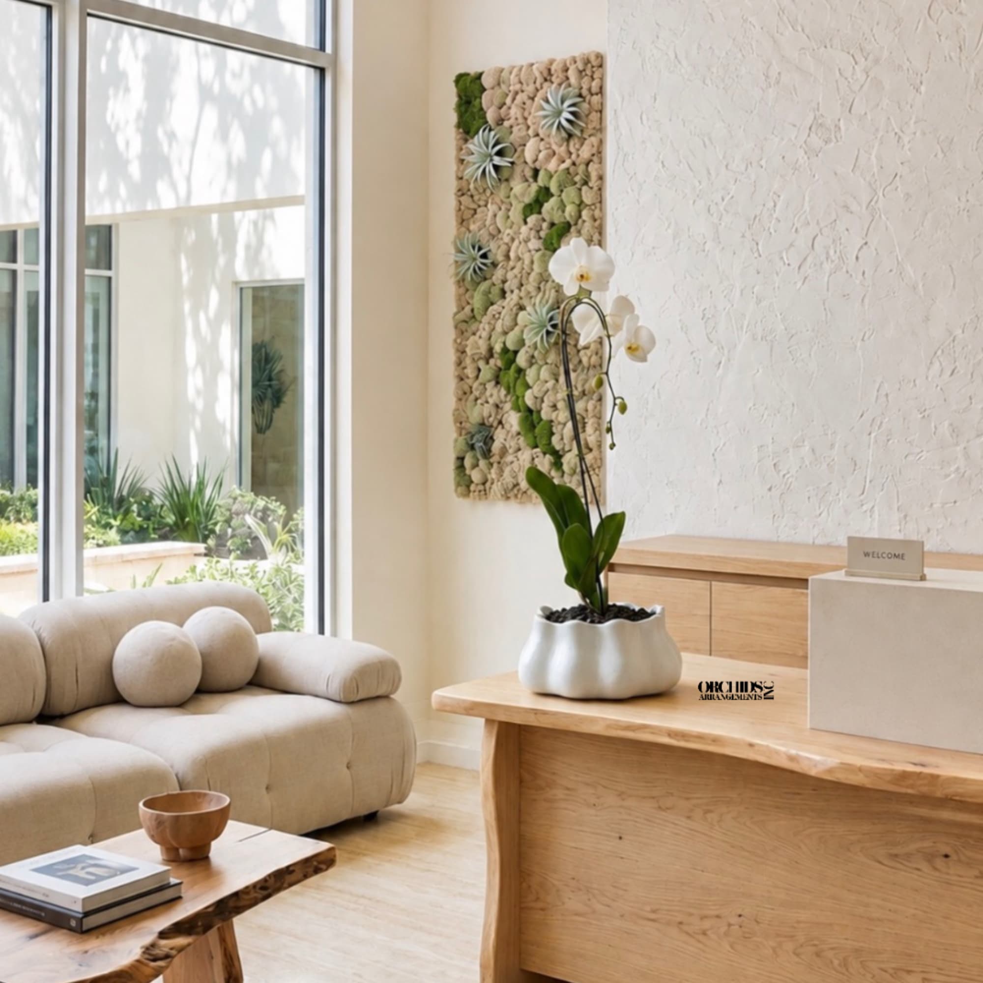 White orchid plant in a sculptural pot on a wooden table
