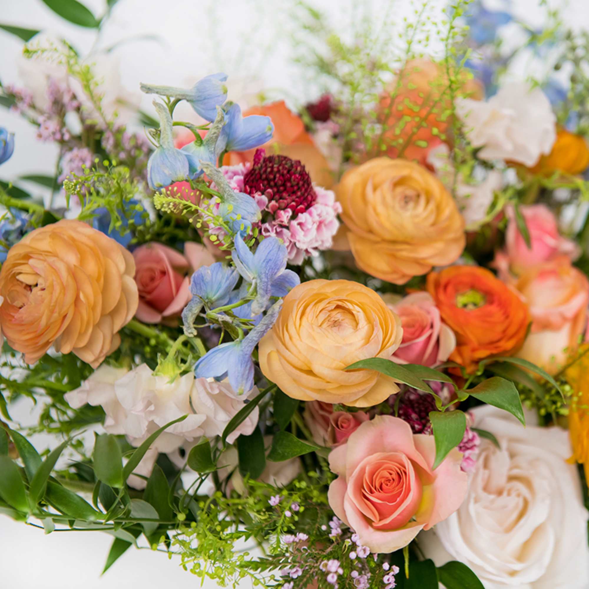 Mixed bouquet with peach, pink, white, and blue flowers