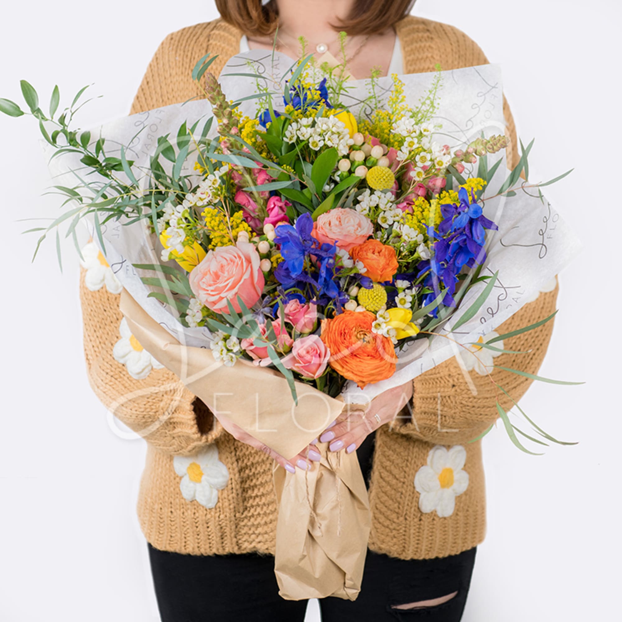 Large mixed bouquet with colorful flowers wrapped in paper