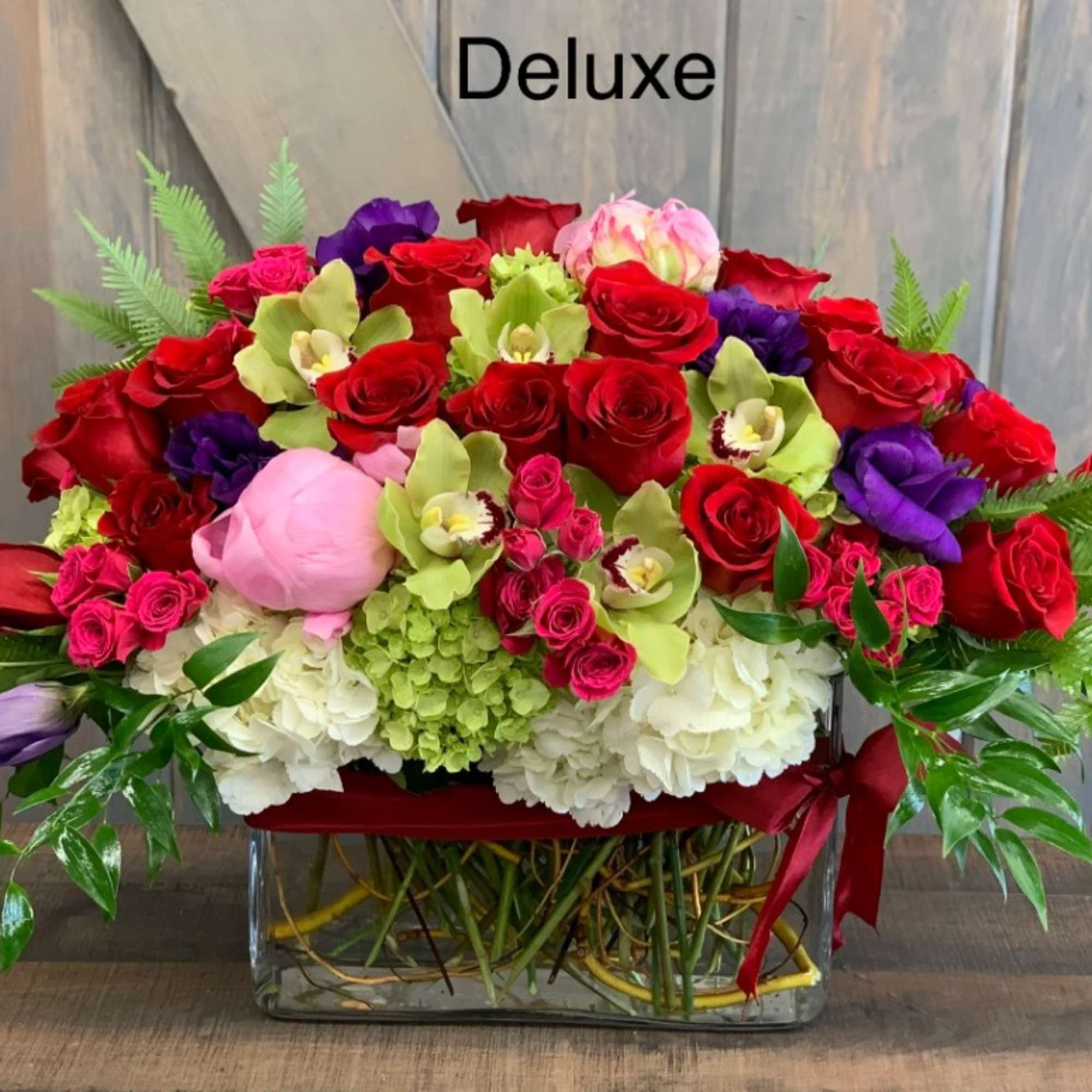 Large mixed bouquet of red and pink roses in a glass vase