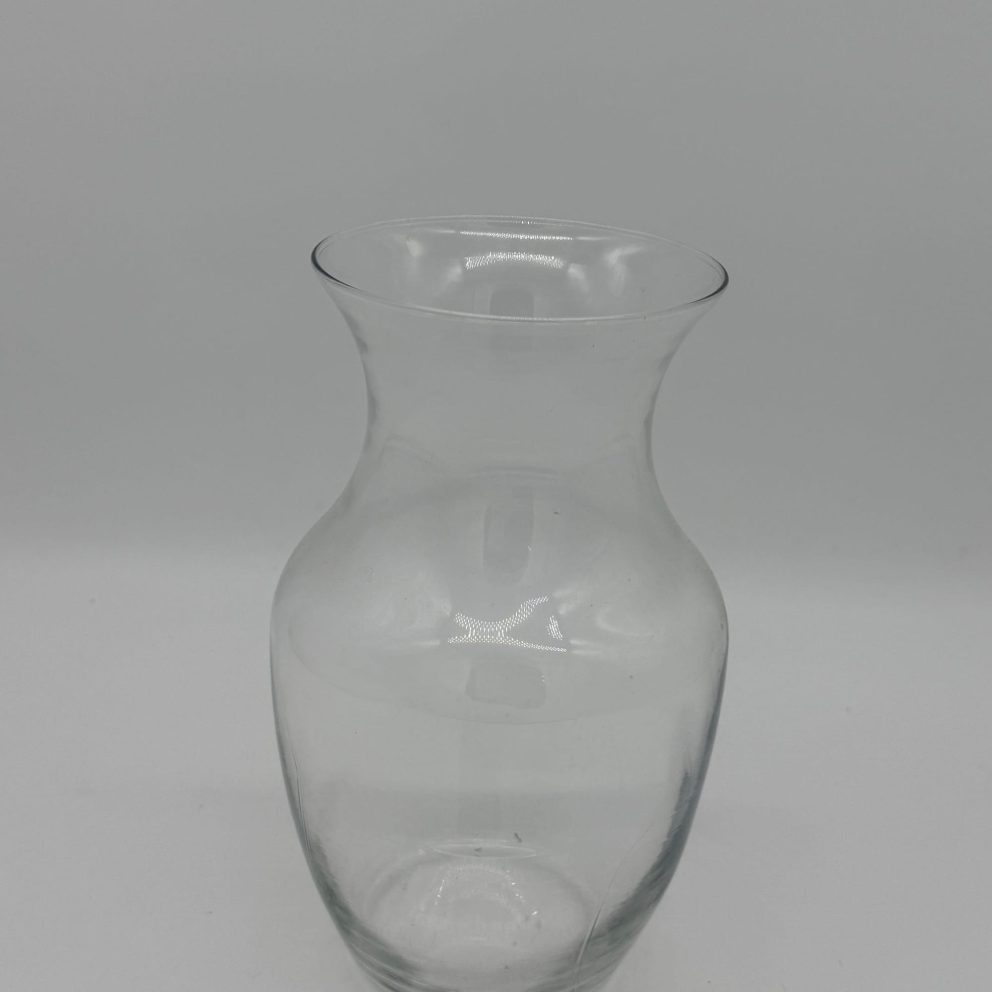 Clear glass vase with a flared rim and narrow neck