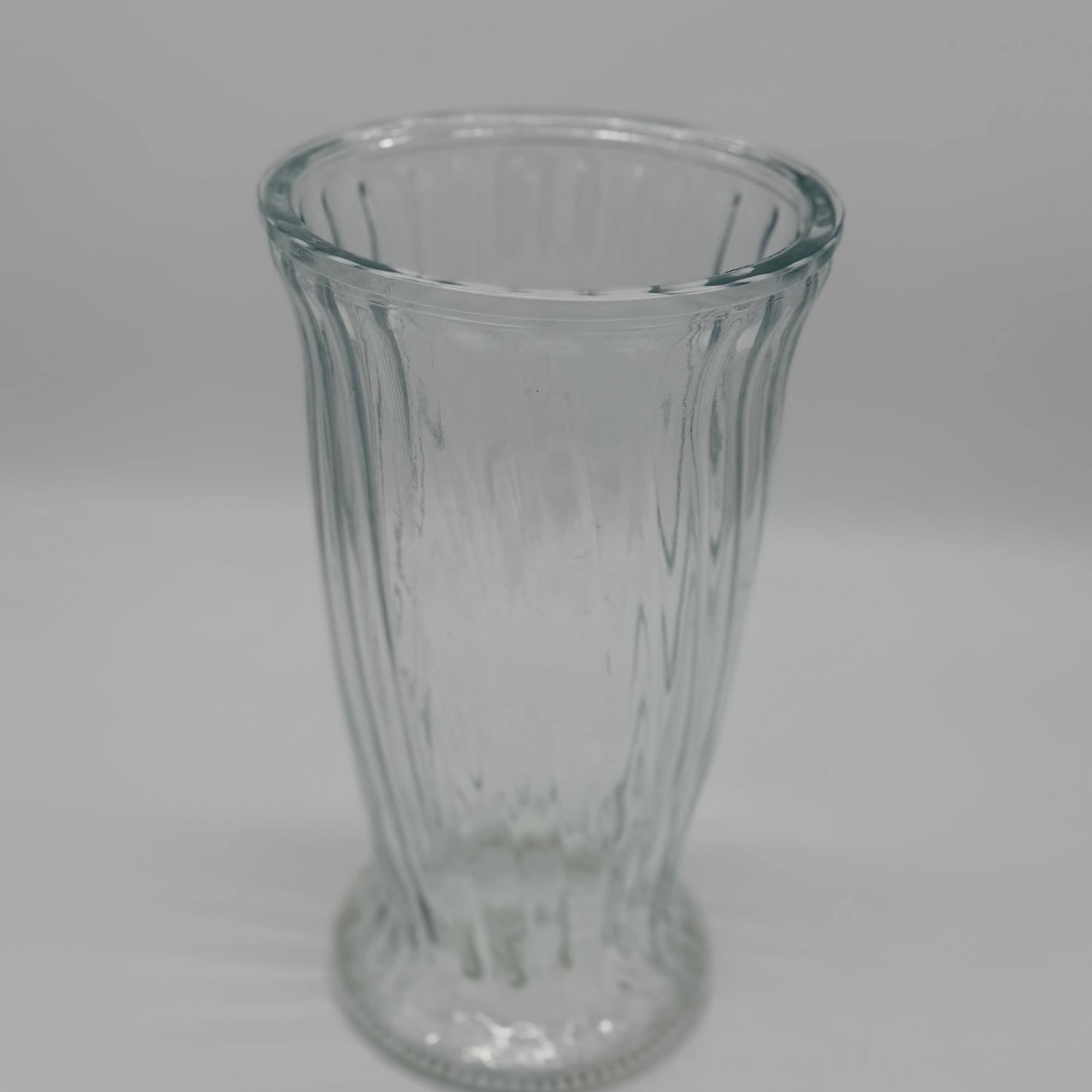 Clear glass vase with a flared top and narrow base