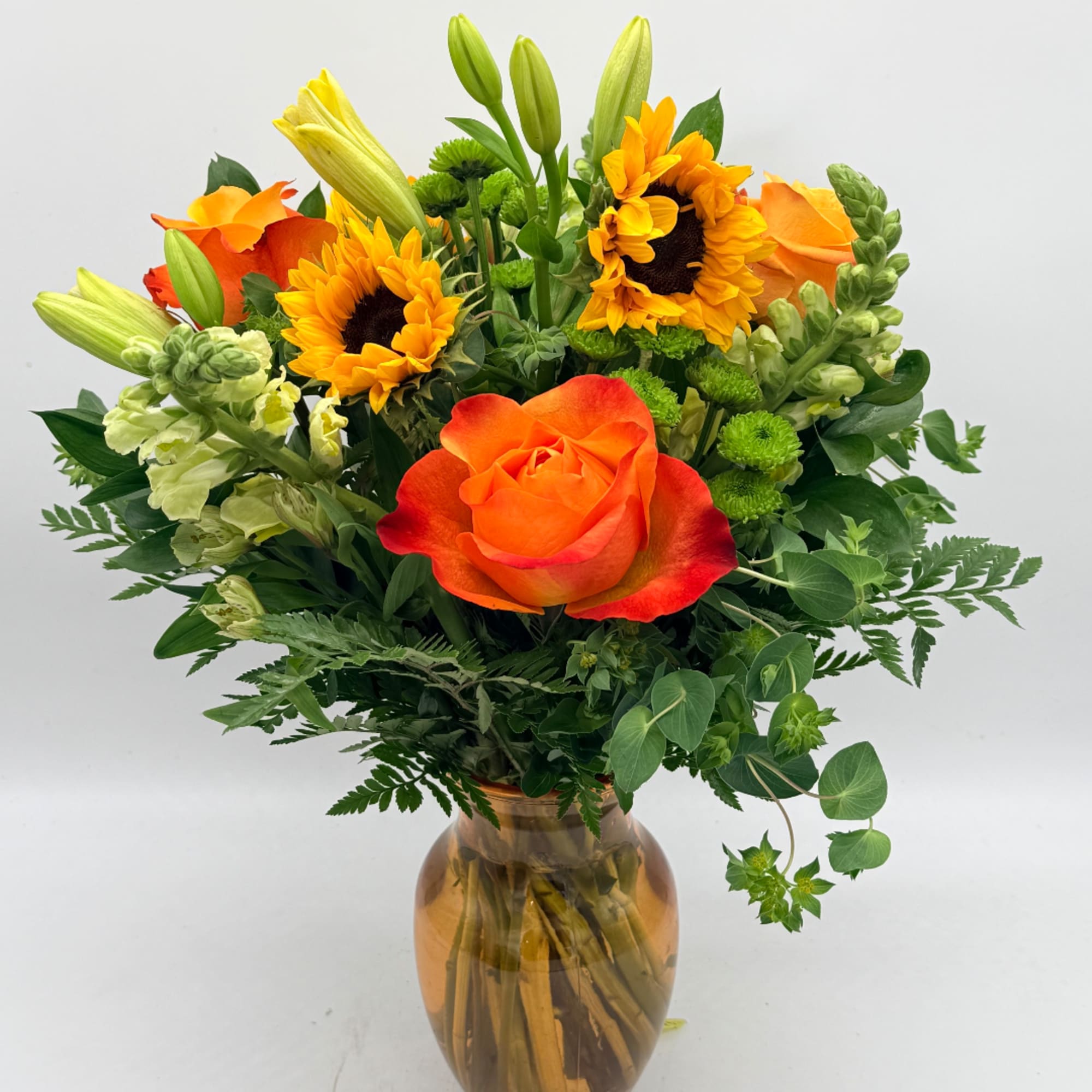 Orange rose and sunflowers in an amber glass vase, photo 2 of 2