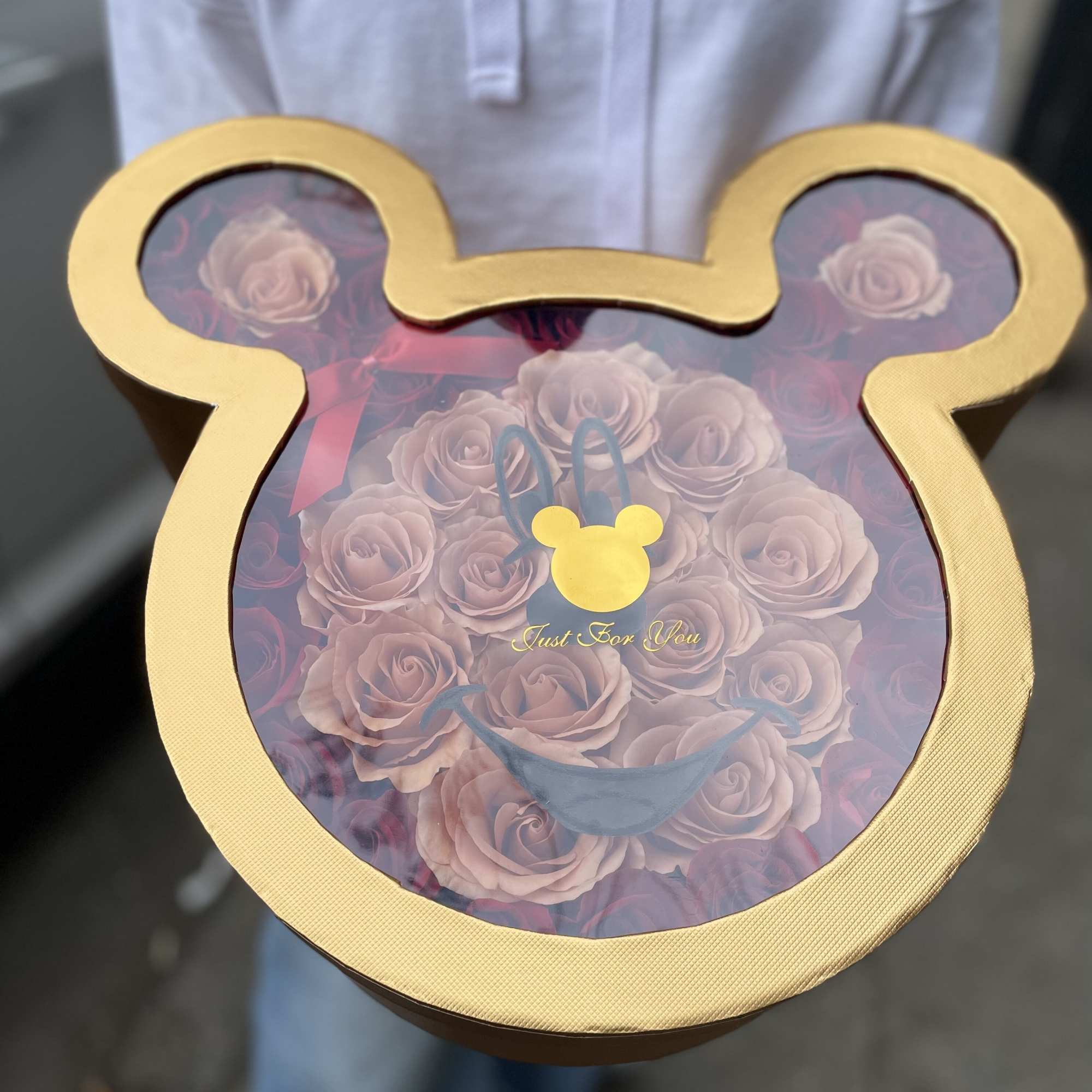 Mickey-shaped gift box filled with pale pink roses