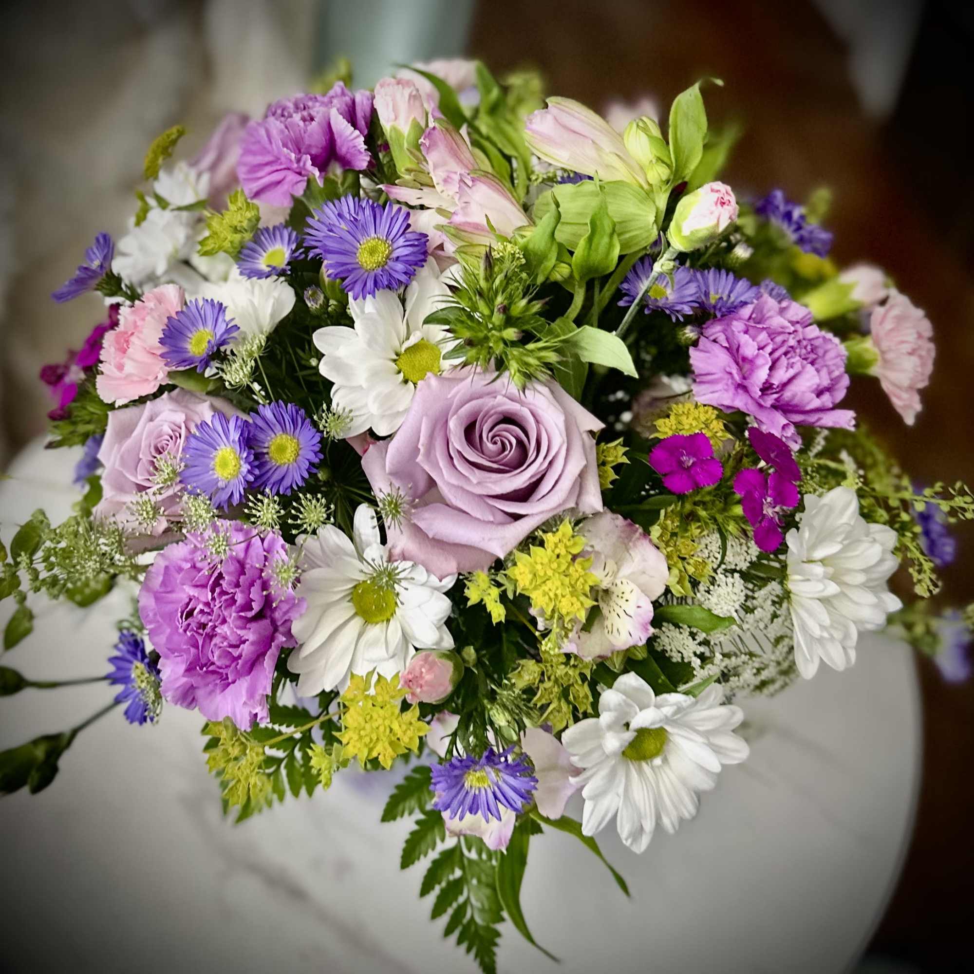 Mixed bouquet with lavender roses, purple daisies, and white daisies