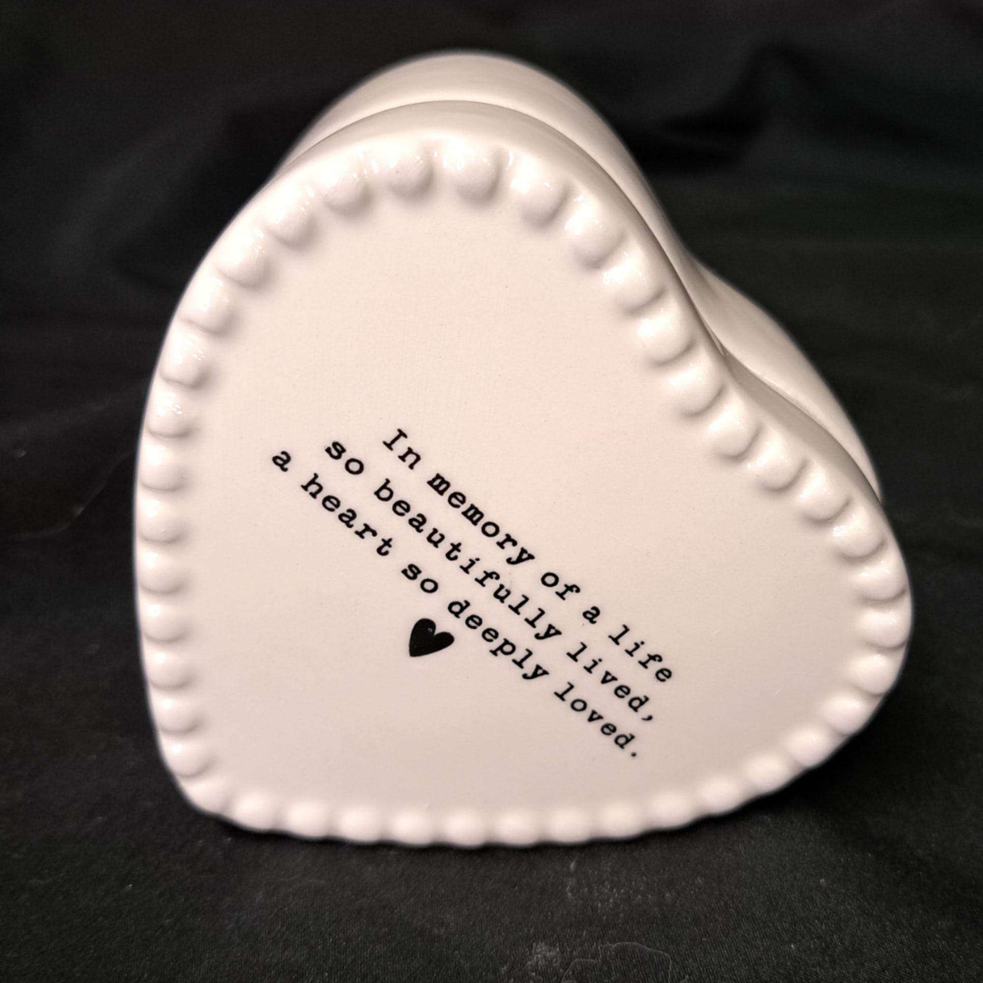 White heart-shaped ceramic keepsake with printed memorial text
