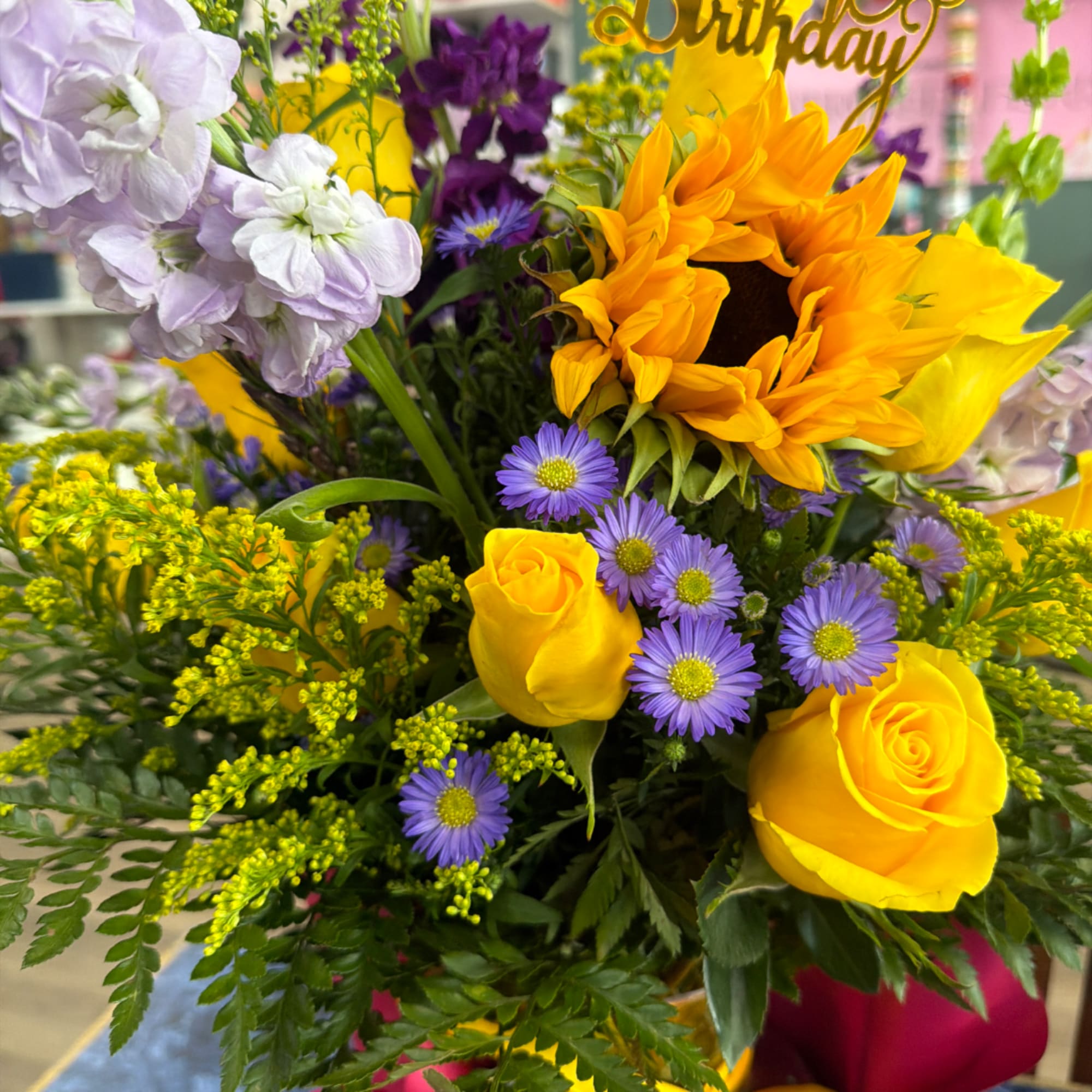 Bouquet with sunflowers, yellow roses, and purple flowers