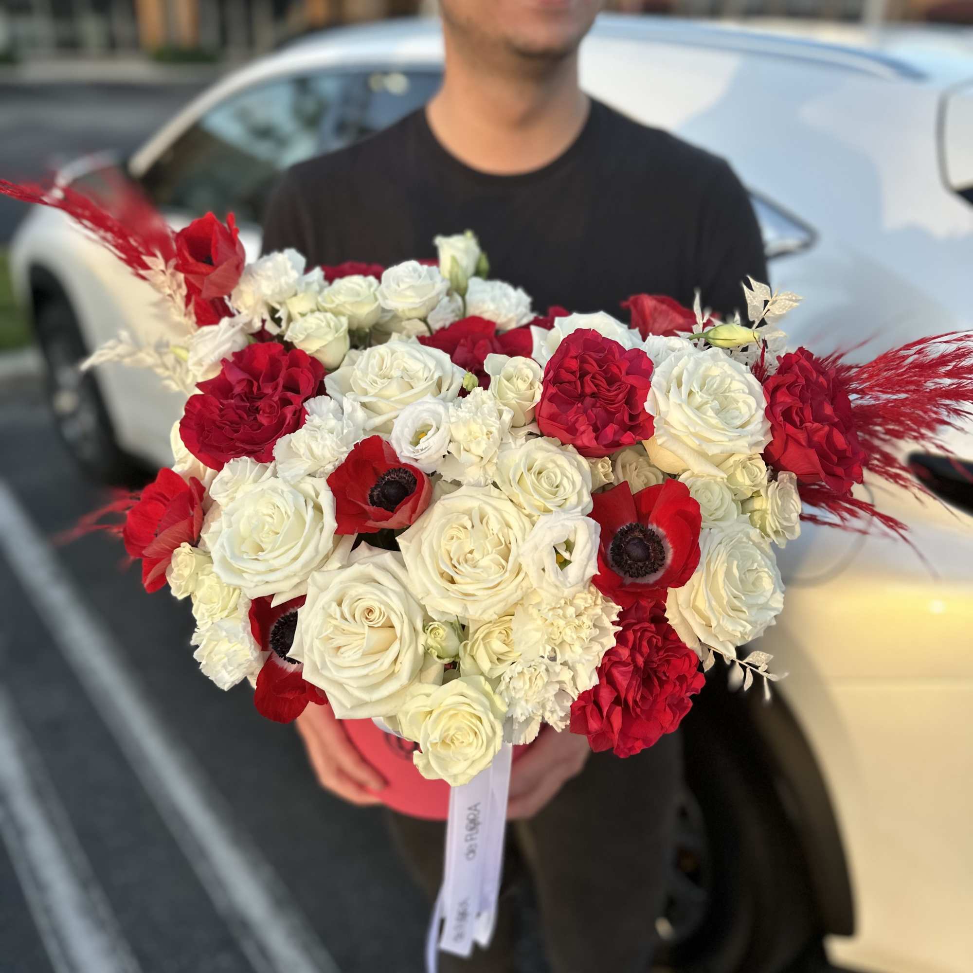 Large bouquet of red and white roses with red accents