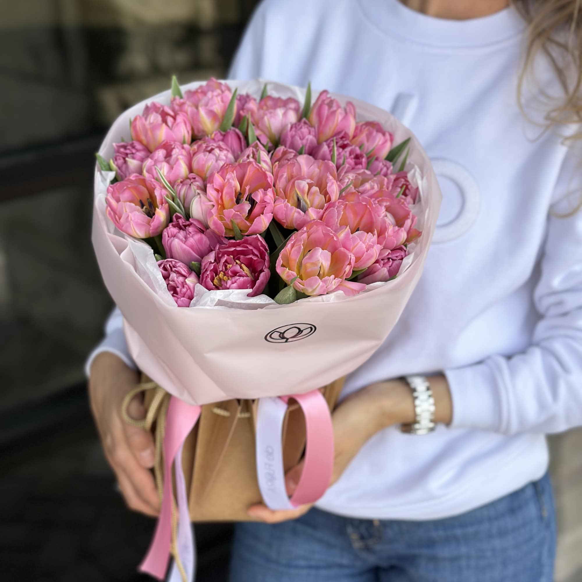 Pink tulip bouquet wrapped in pale pink paper