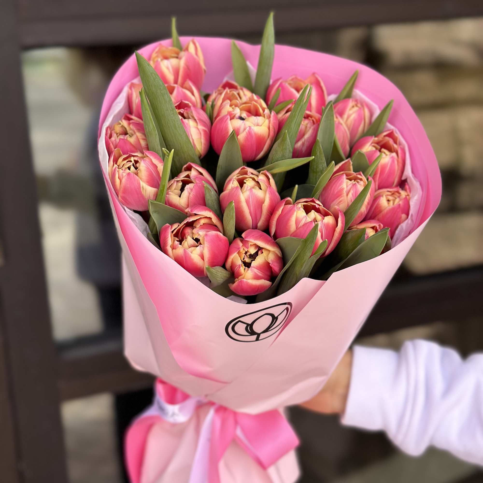 Bouquet of pink tulips wrapped in pink paper with a ribbon, photo 4 of 6