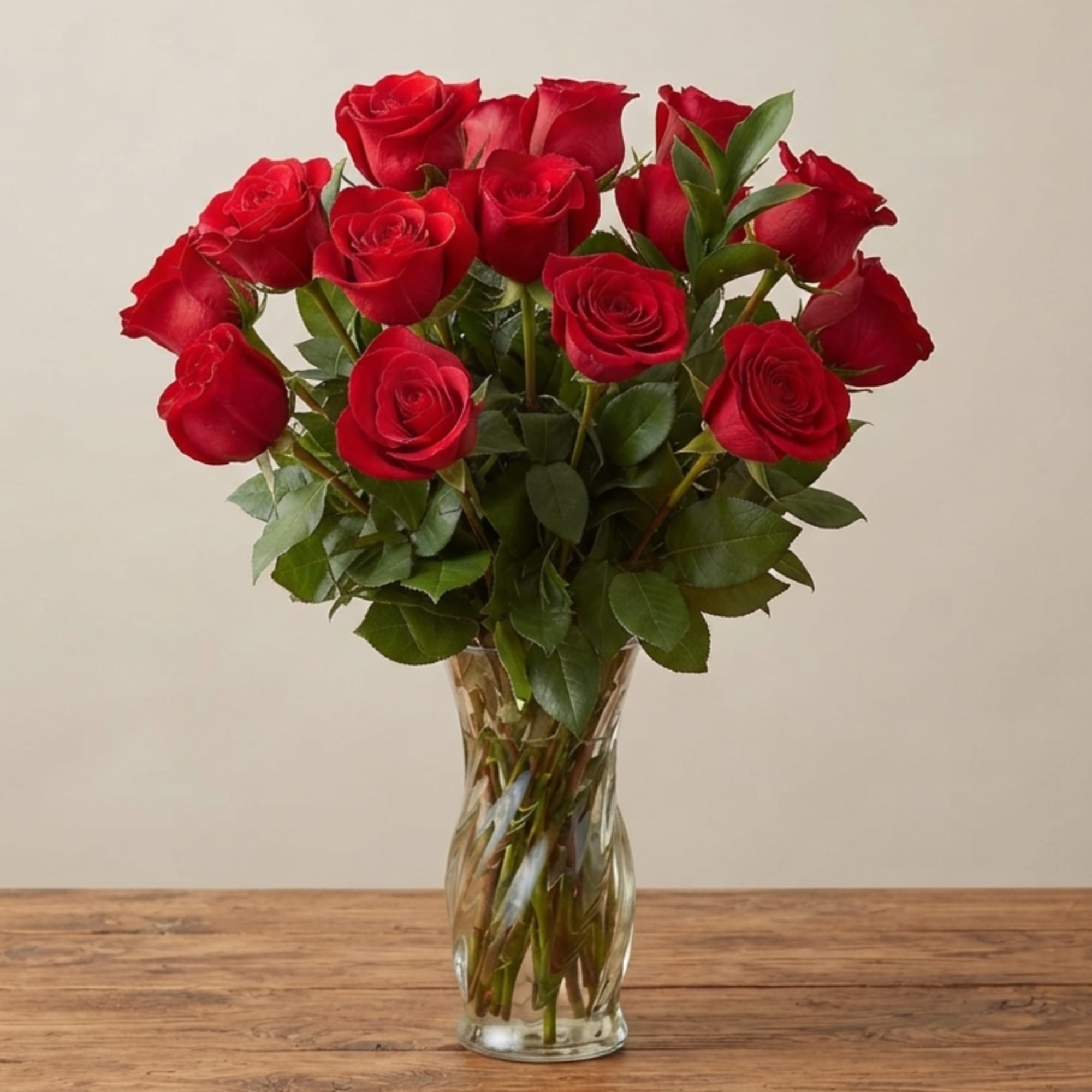 Red roses arranged in a clear glass vase