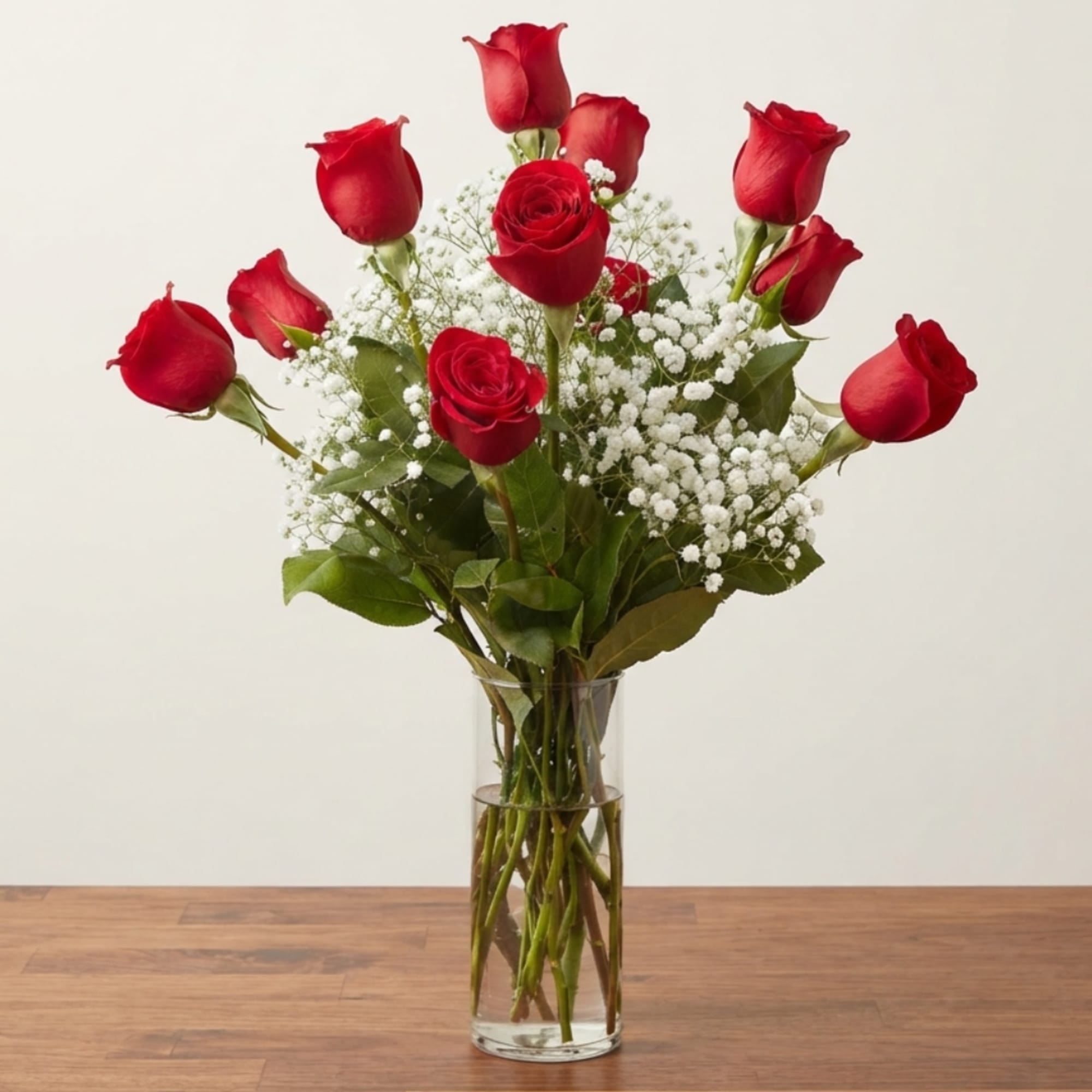 Red roses arranged in a clear glass vase with white baby's breath, photo 3 of 3