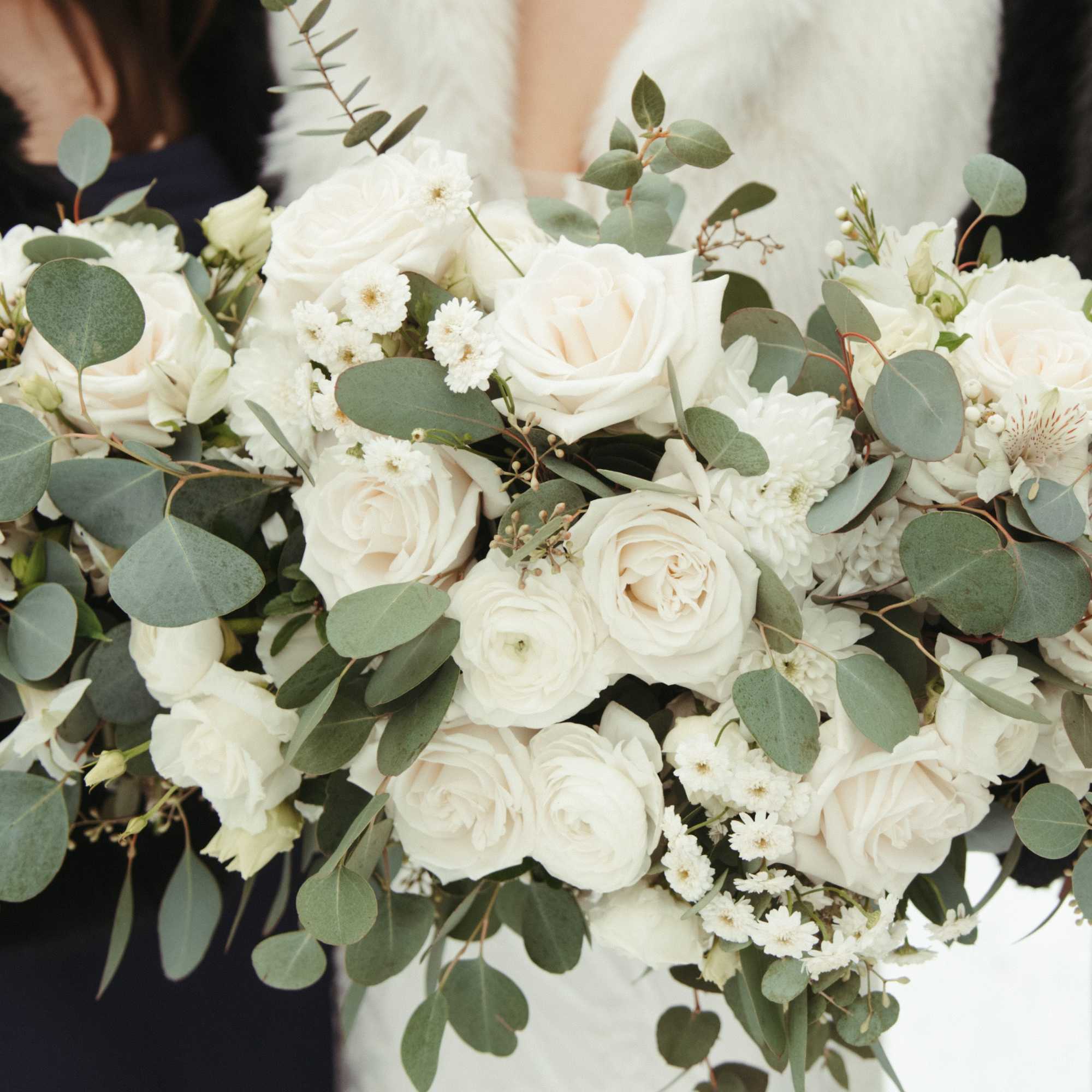 White rose bouquet with eucalyptus and small white filler flowers