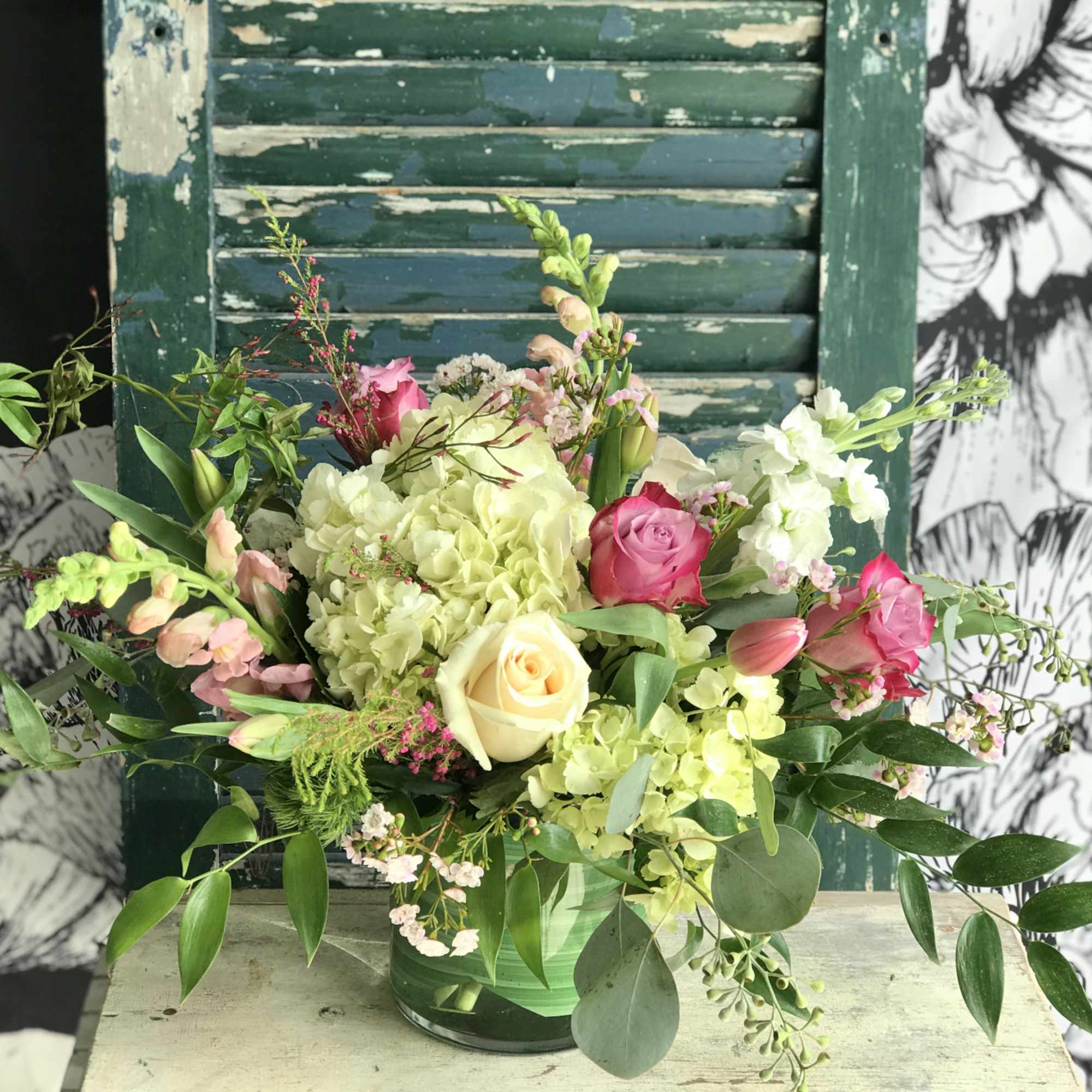 Mixed bouquet in a glass vase with pink and cream roses