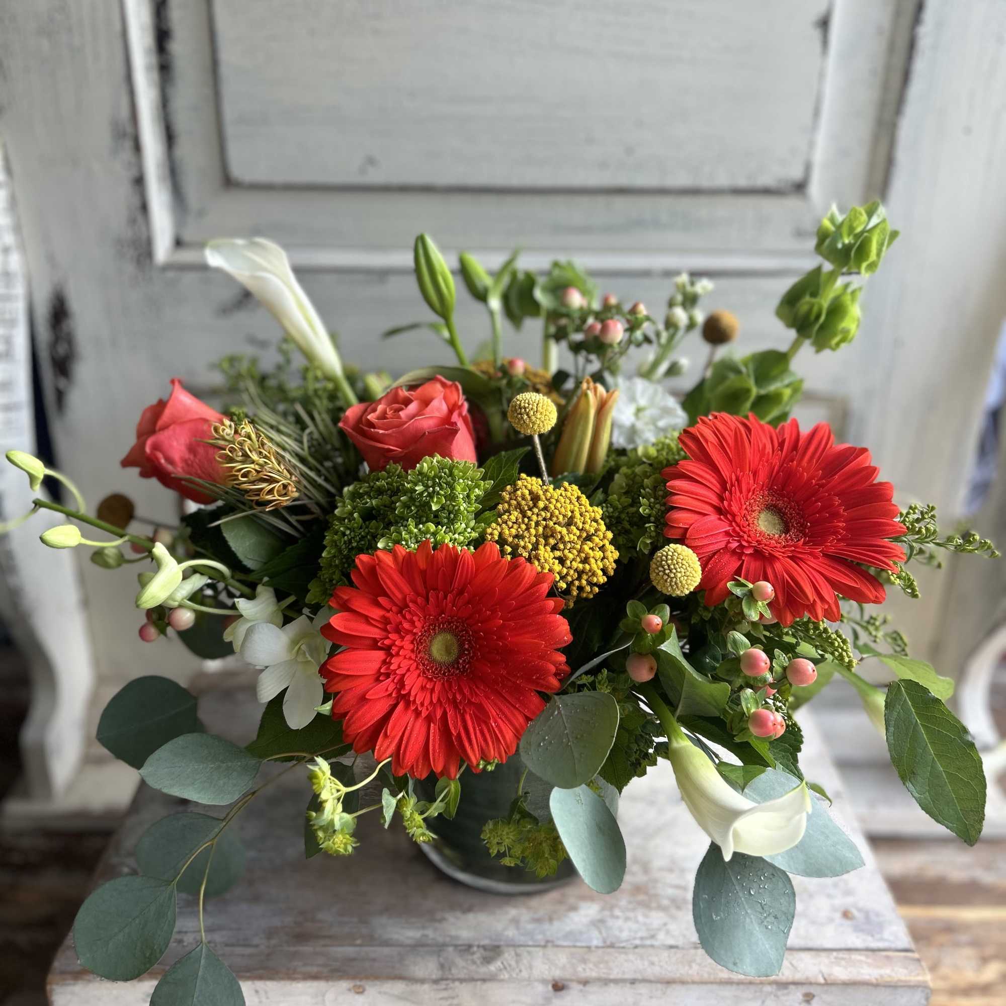 Bouquet with red gerbera daisies, red roses, and white calla lilies
