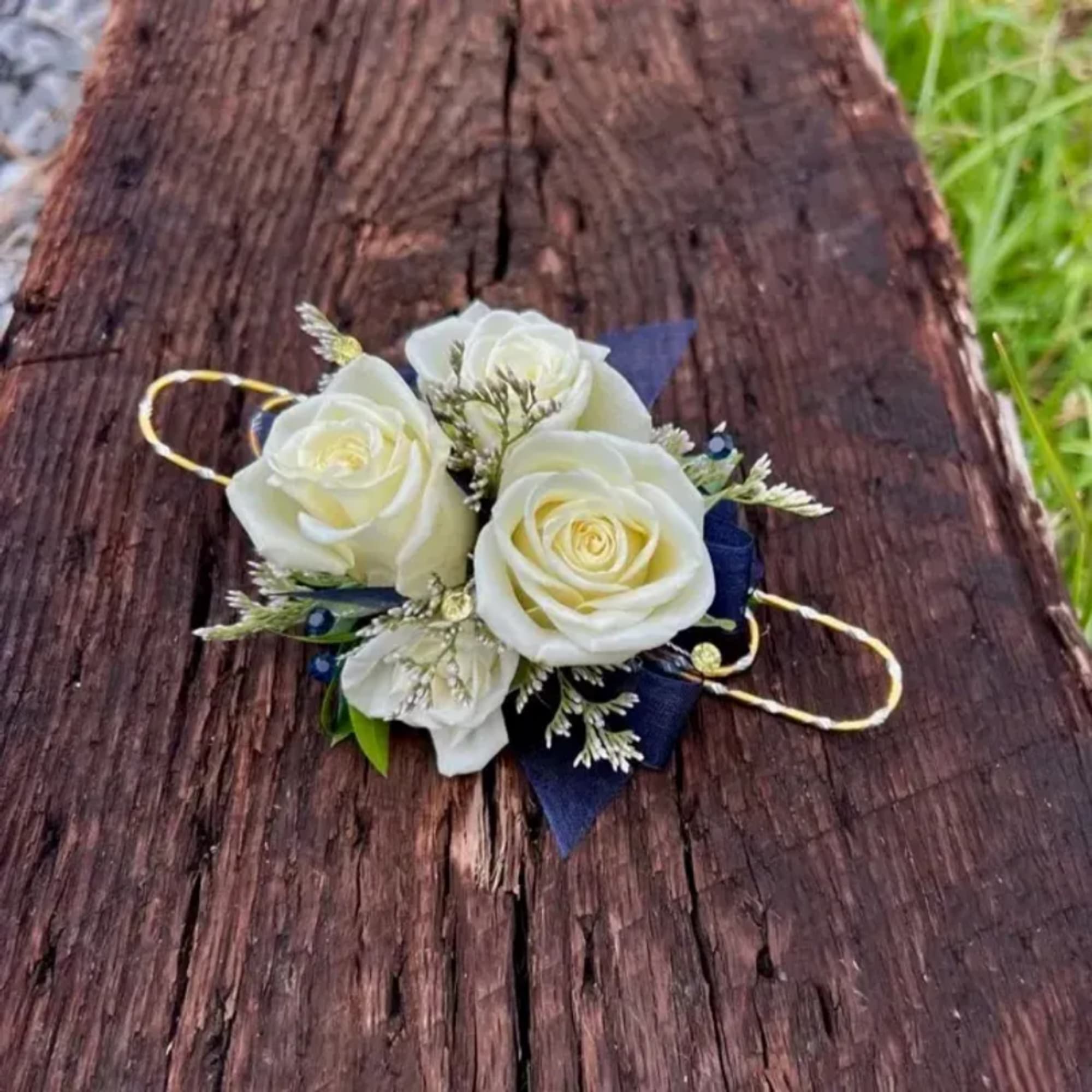 White rose boutonniere with navy ribbon on a wooden surface, photo 2 of 3