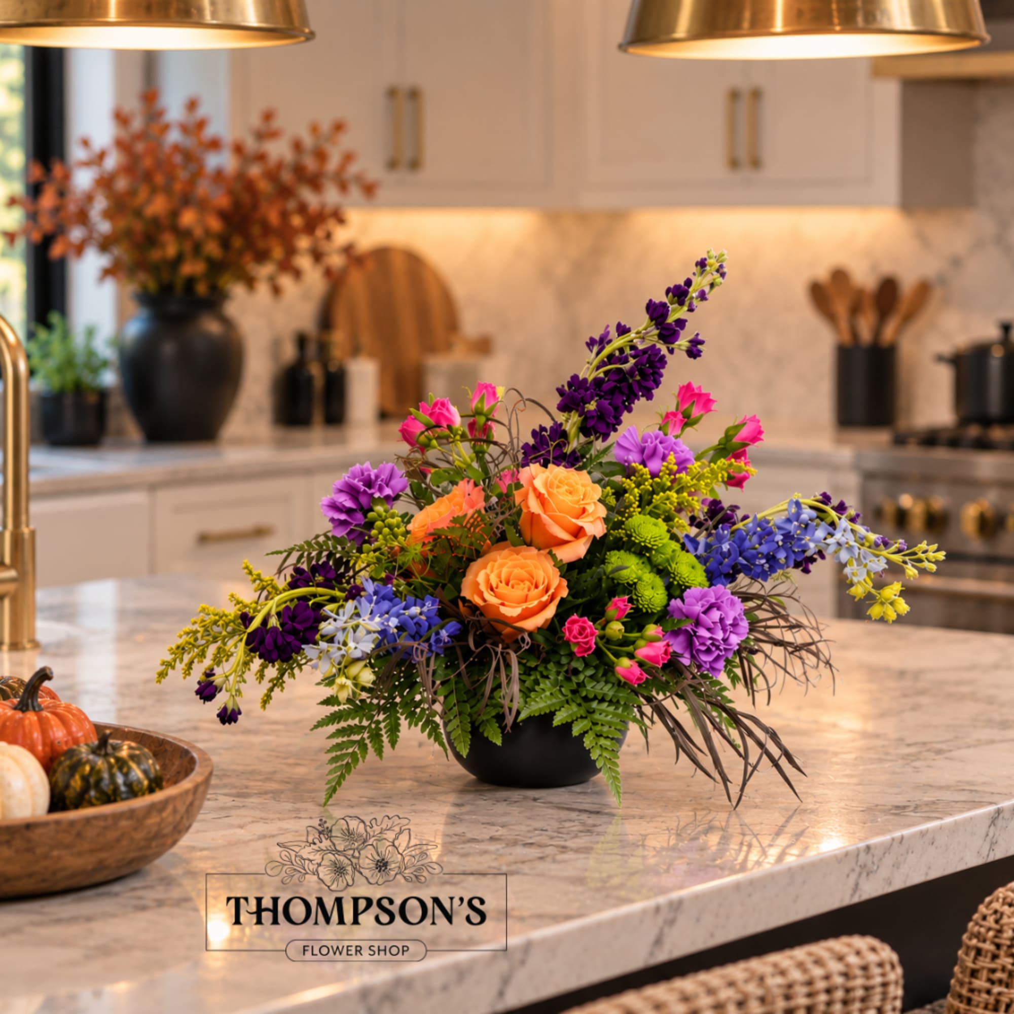 Colorful flower arrangement in a black bowl on a kitchen island