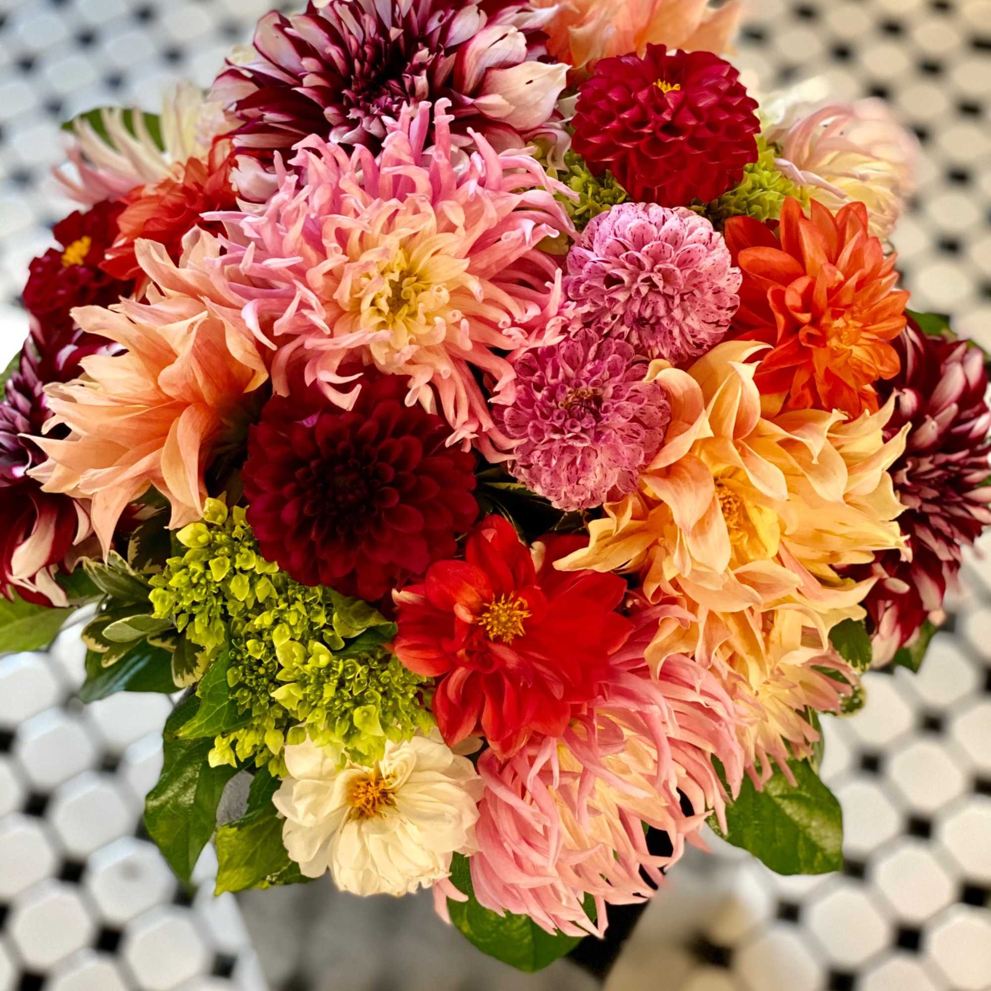 Mixed bouquet of colorful dahlias with green foliage