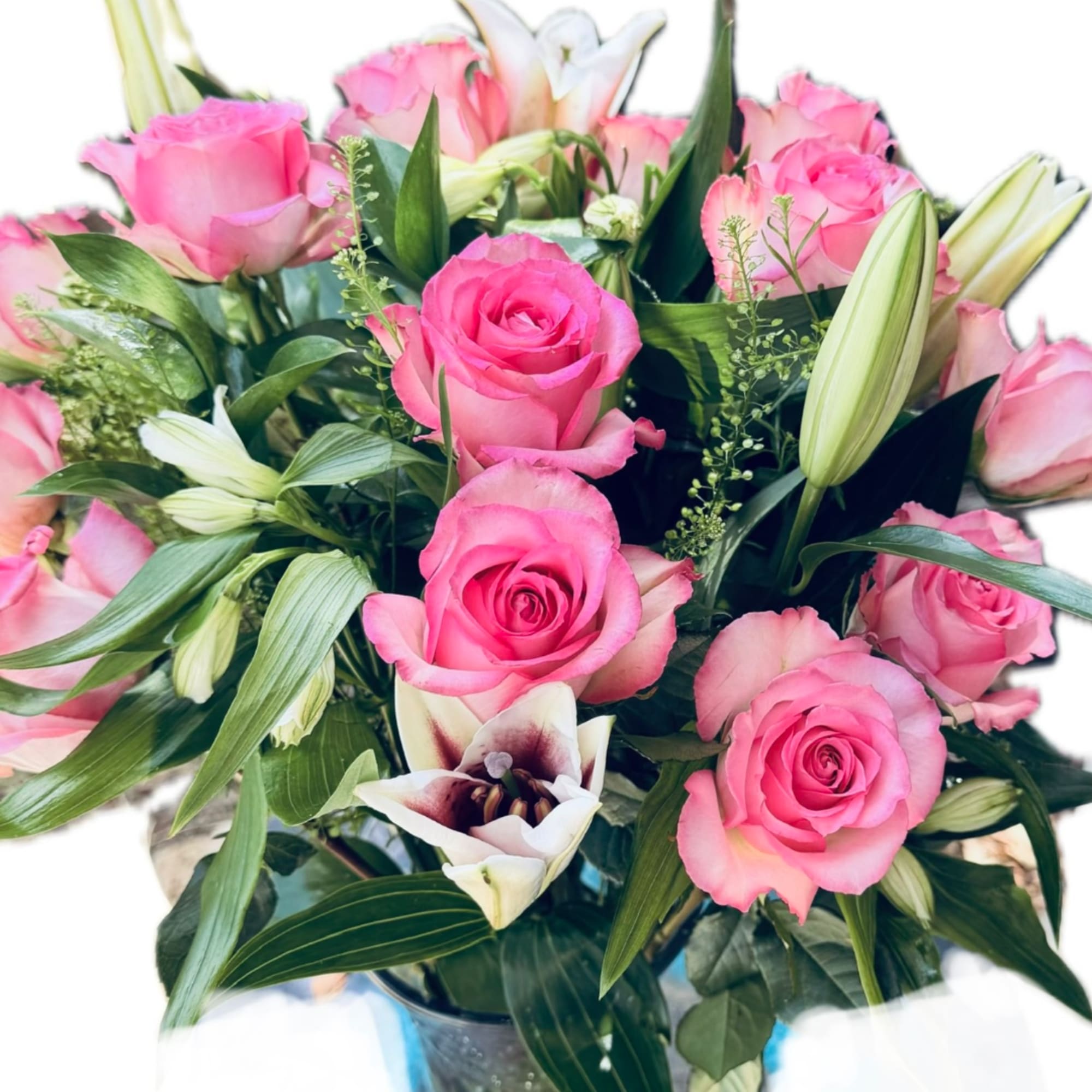 Pink roses and white lilies in a glass vase