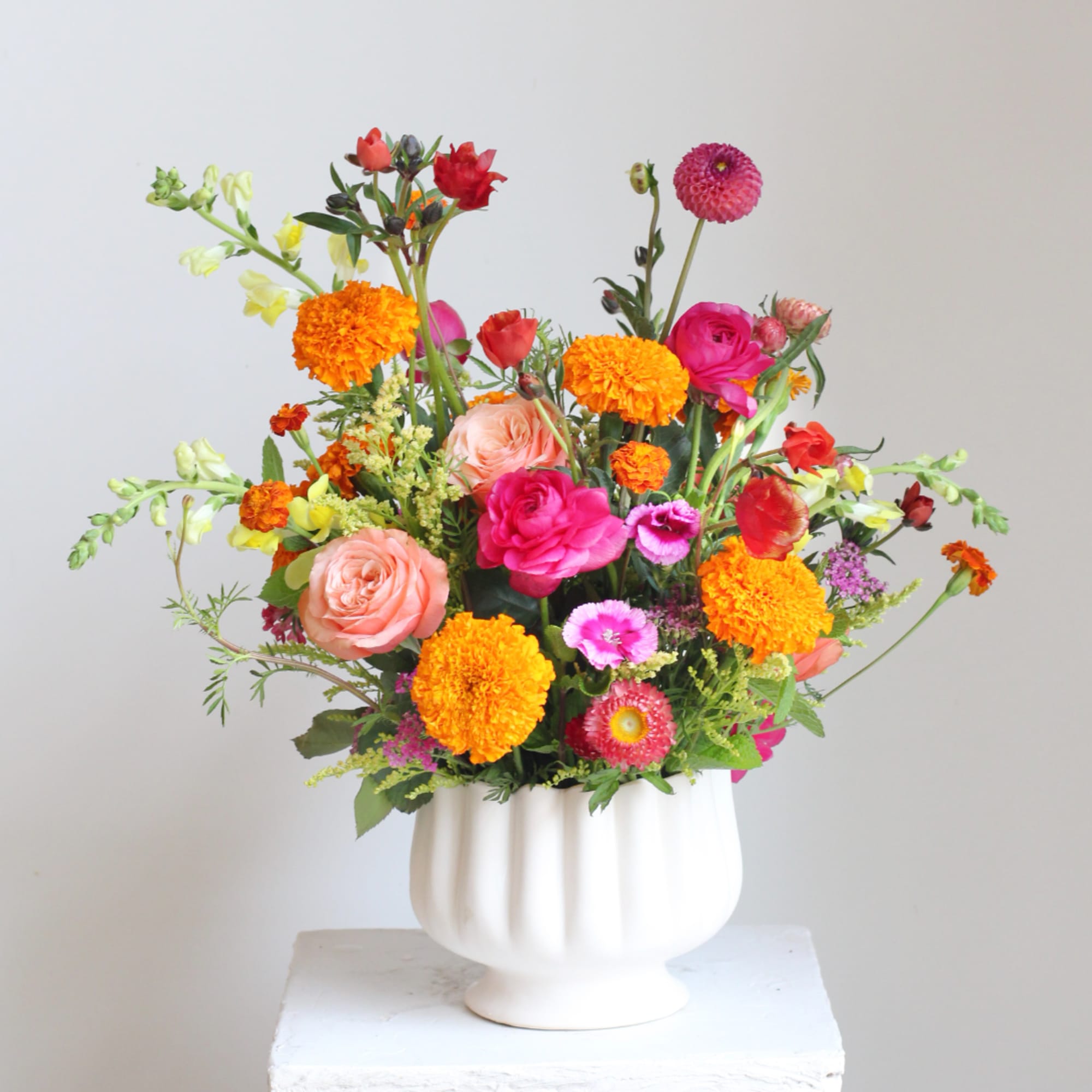 Colorful mixed bouquet in a white vase