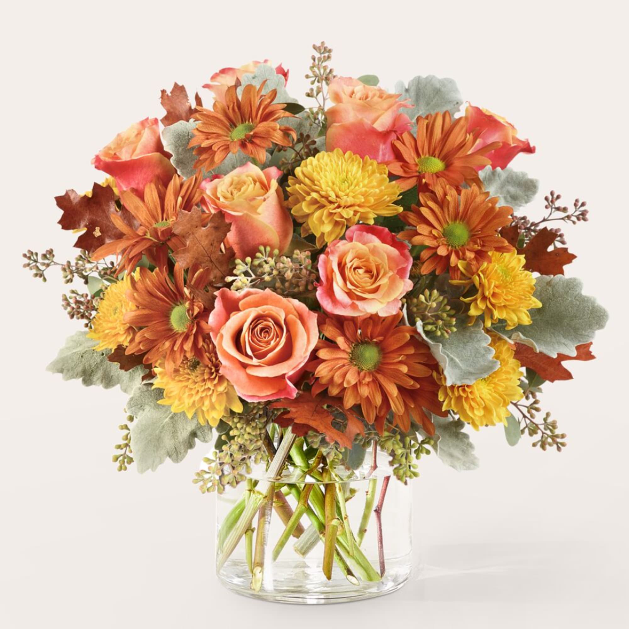 Orange and yellow flowers in a clear glass vase