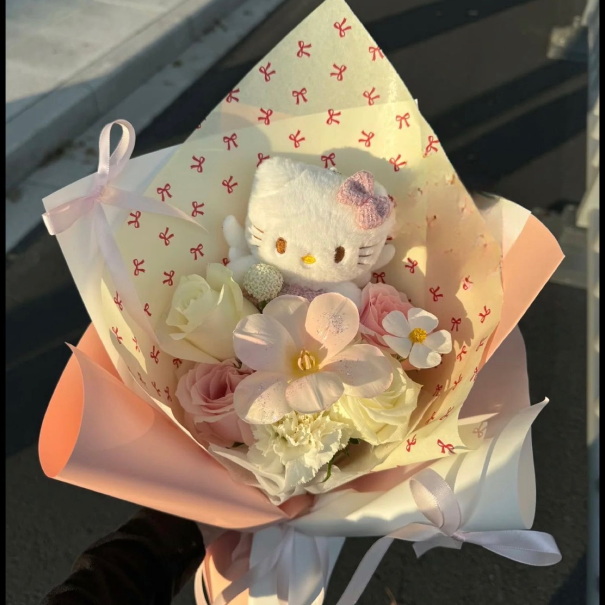 Pastel bouquet with a Hello Kitty plush and pink ribbon wrapping