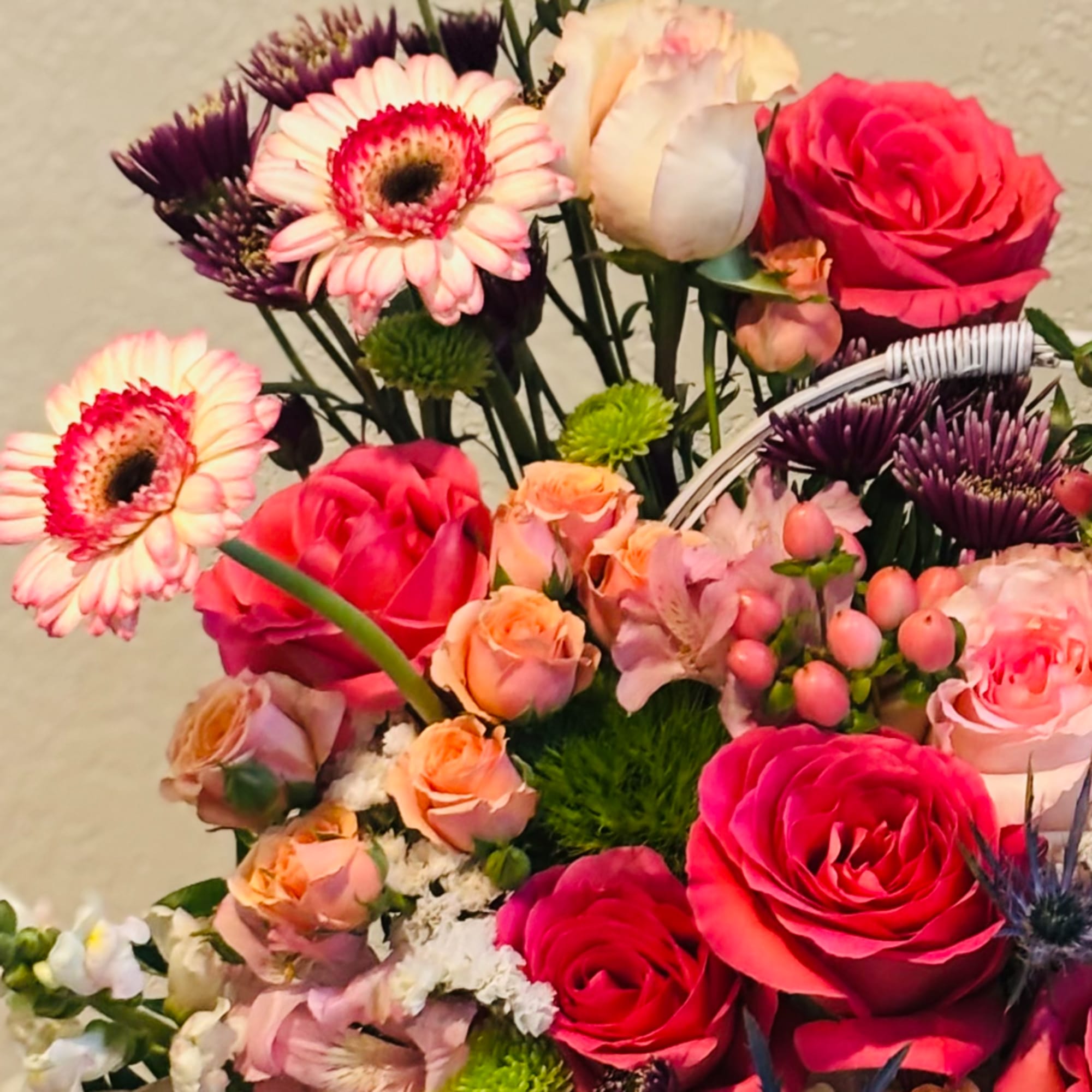 Mixed bouquet with pink roses, gerbera daisies, and purple flowers