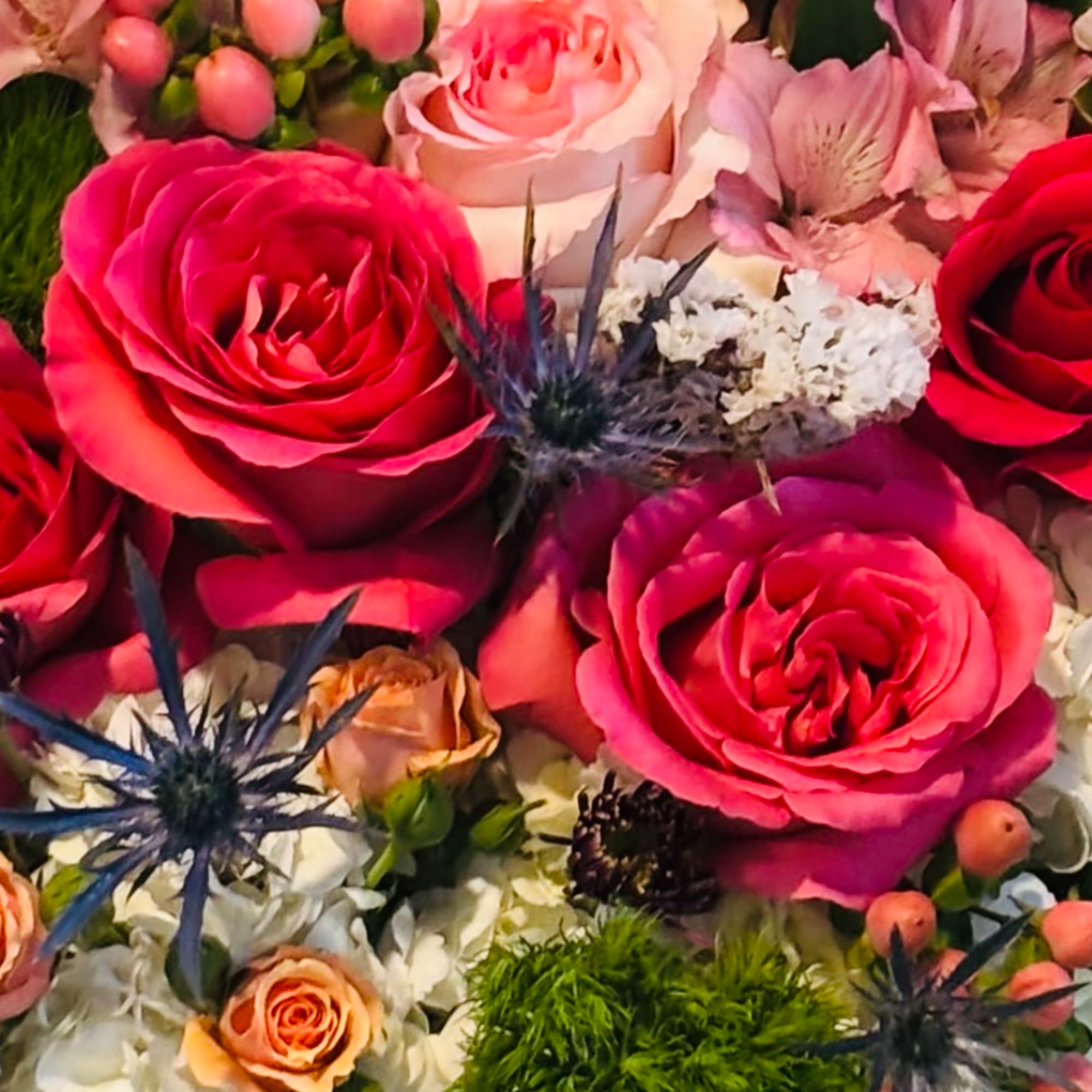 Close-up bouquet of pink and red roses with white filler flowers