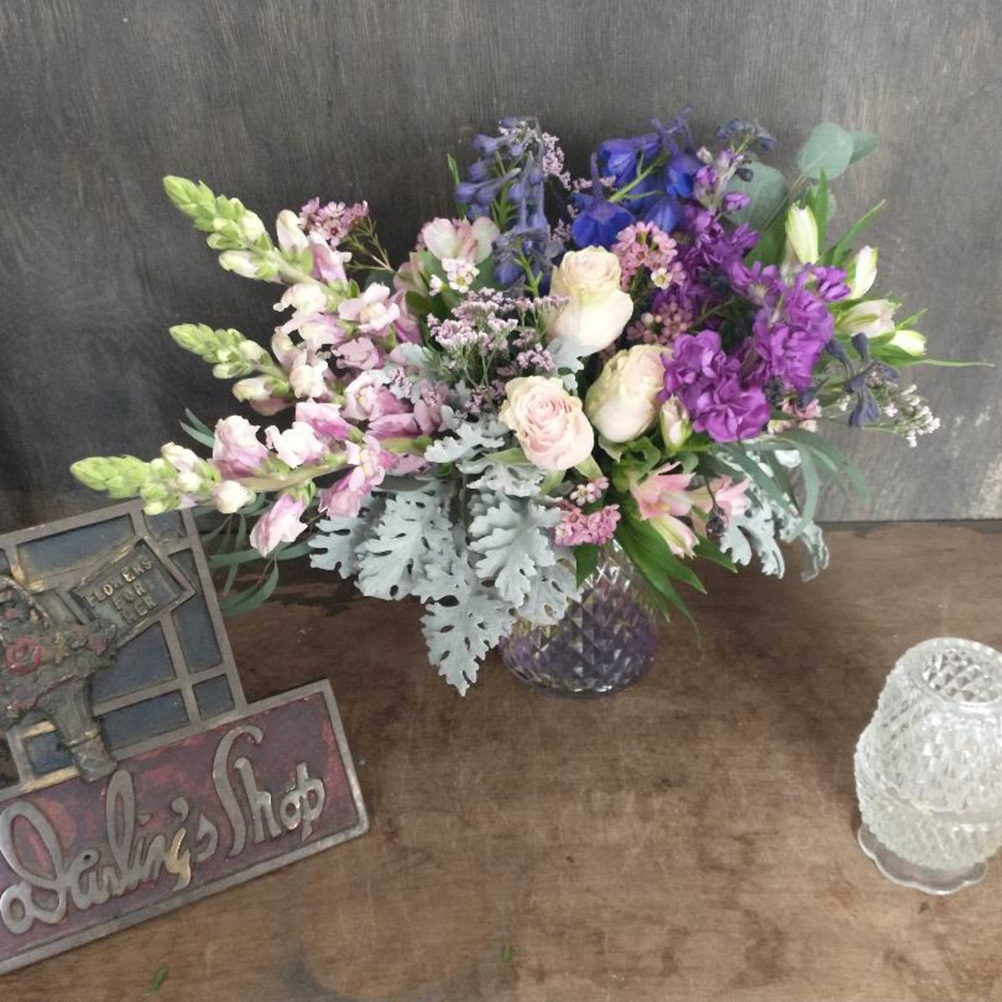 Mixed bouquet of purple, pink, and white flowers in a glass vase, photo 2 of 2