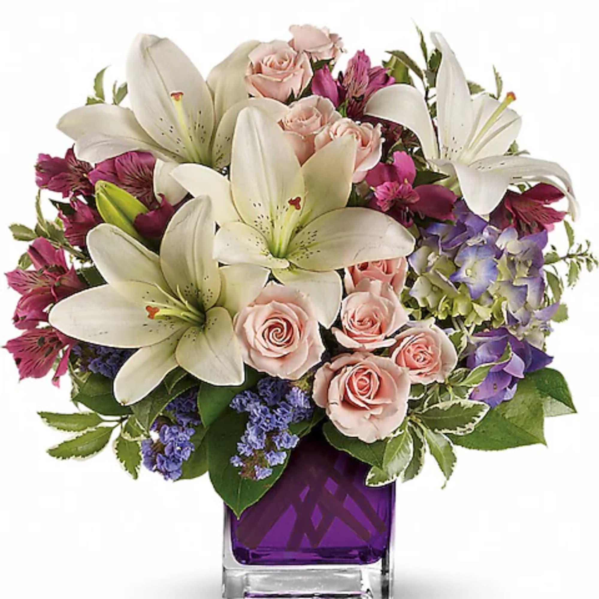 Bouquet of white lilies, pink roses, and purple flowers in a purple vase