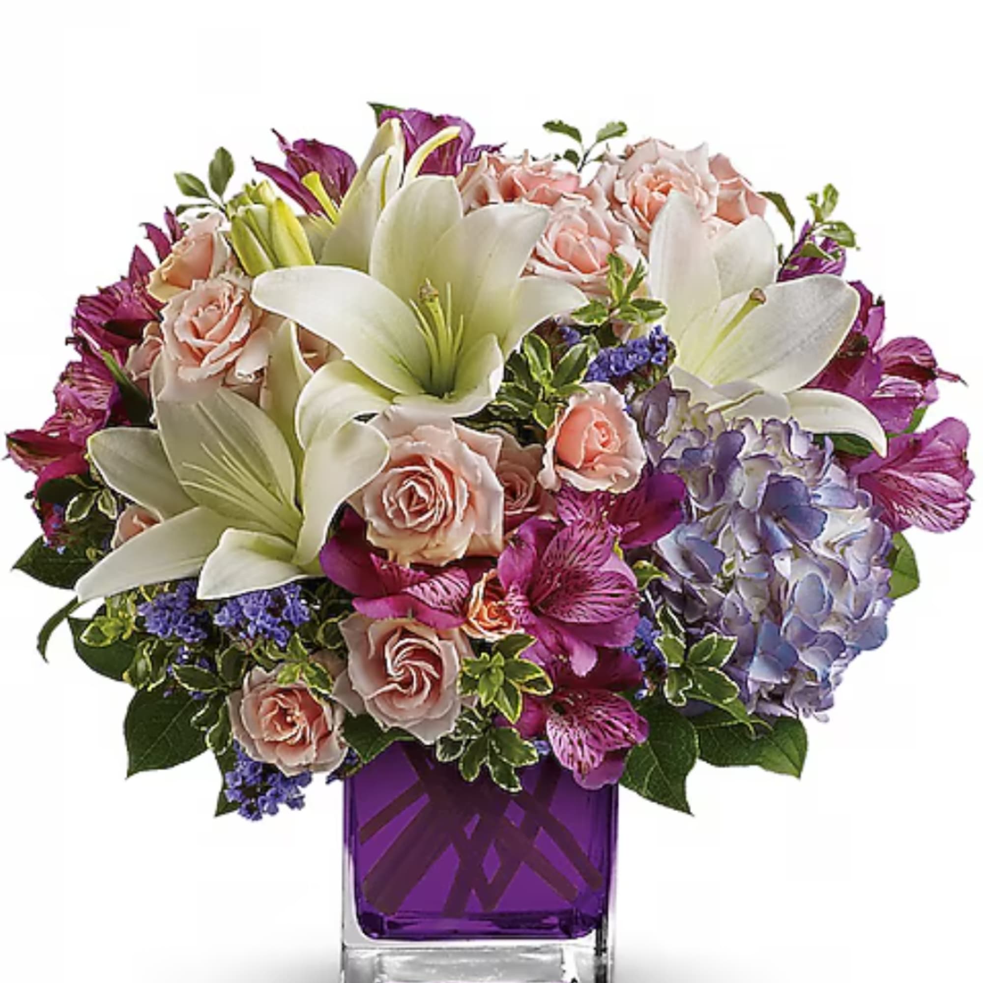 Bouquet of white lilies, pink roses, and purple flowers in a purple vase