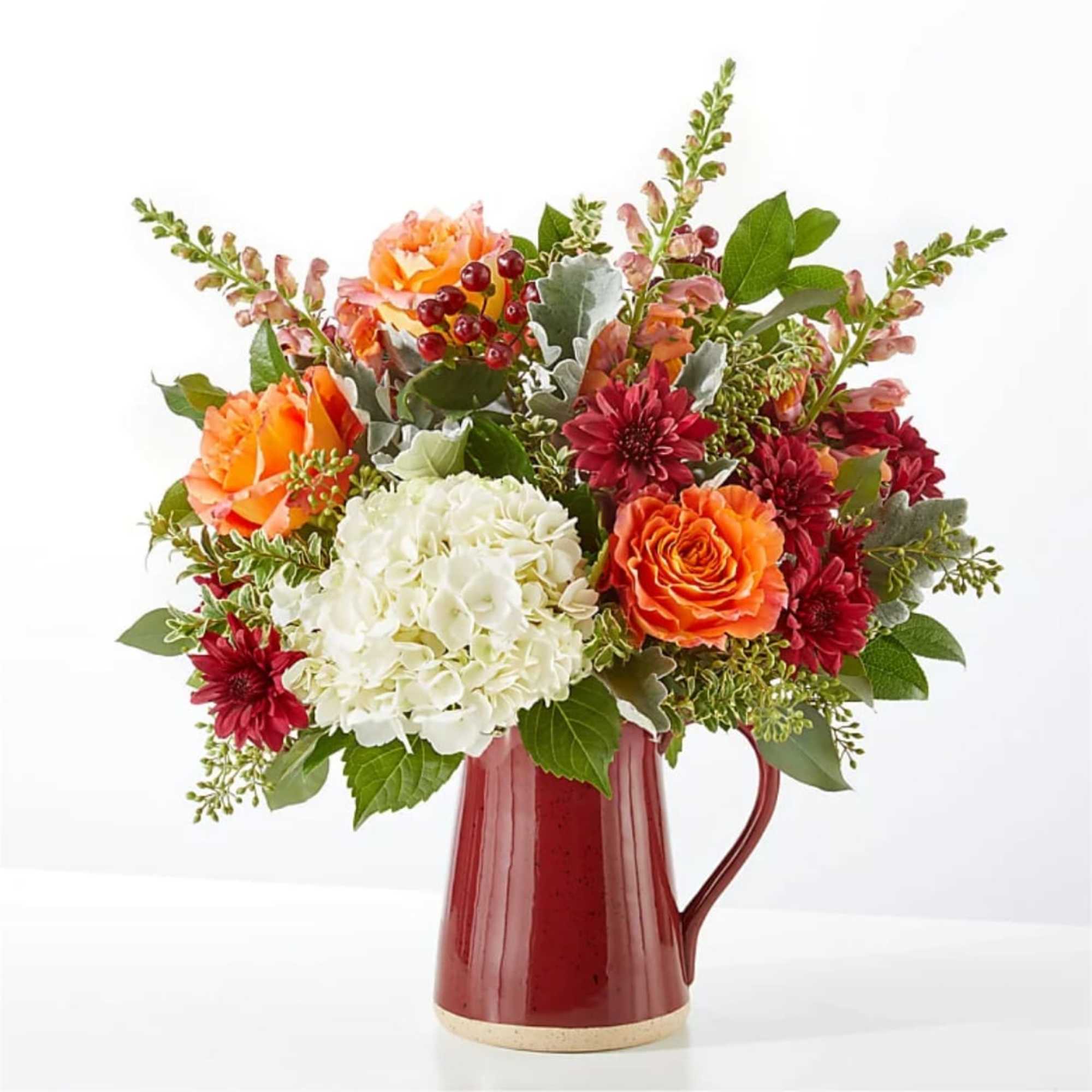 A generous white hydrangea crown anchors this garden-style flower arrangement, surrounded by