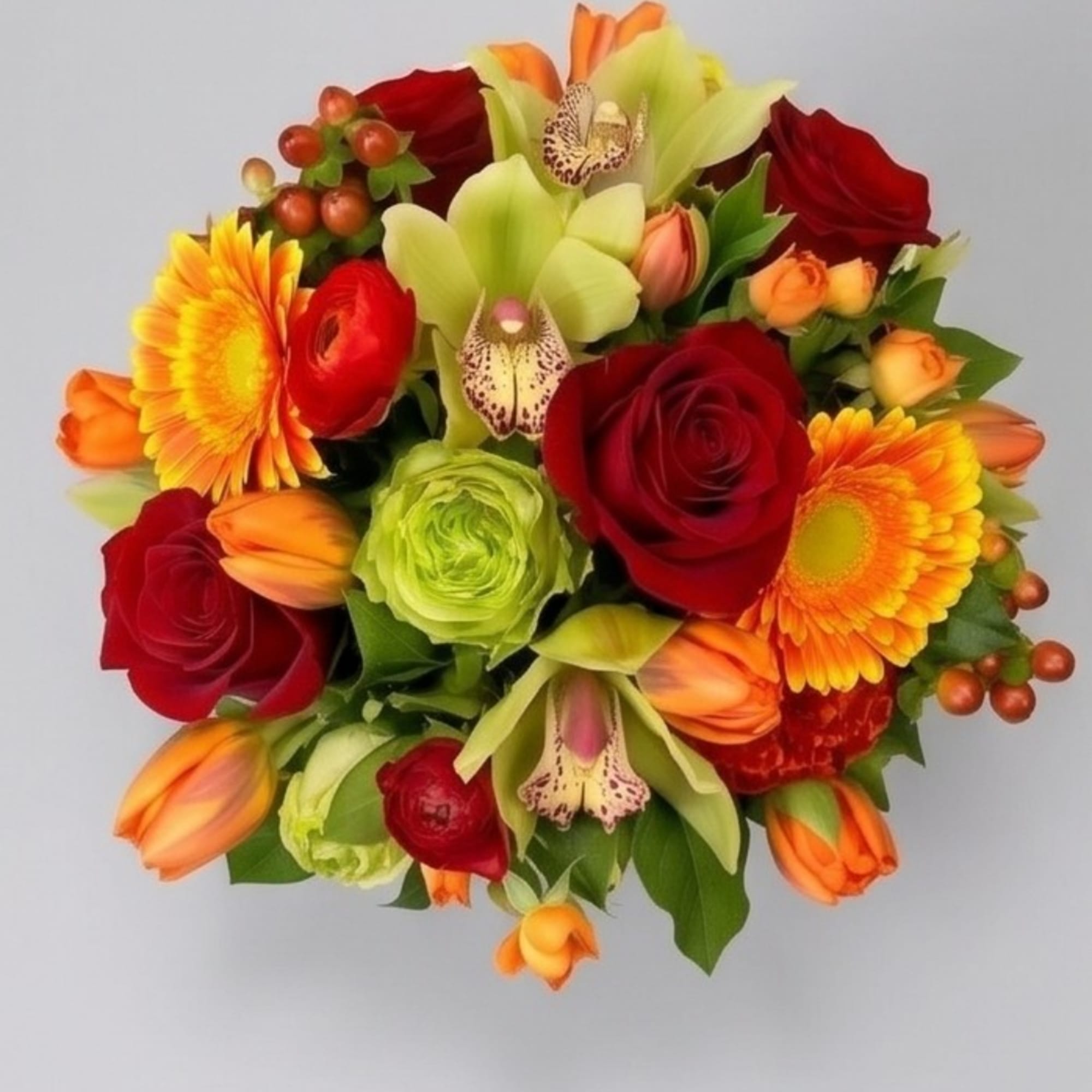 Round bouquet of red roses, orange tulips, and yellow gerbera daisies