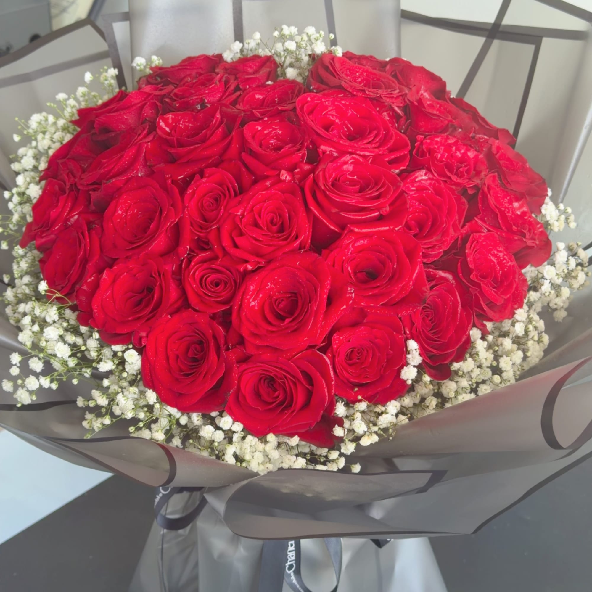 Bouquet of red roses with white baby's breath in gray wrap, photo 5 of 5
