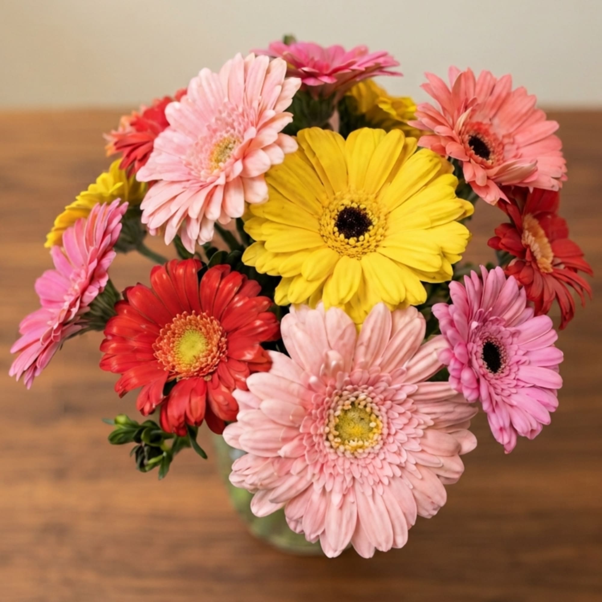 Bouquet of colorful gerbera daisies in a glass vase