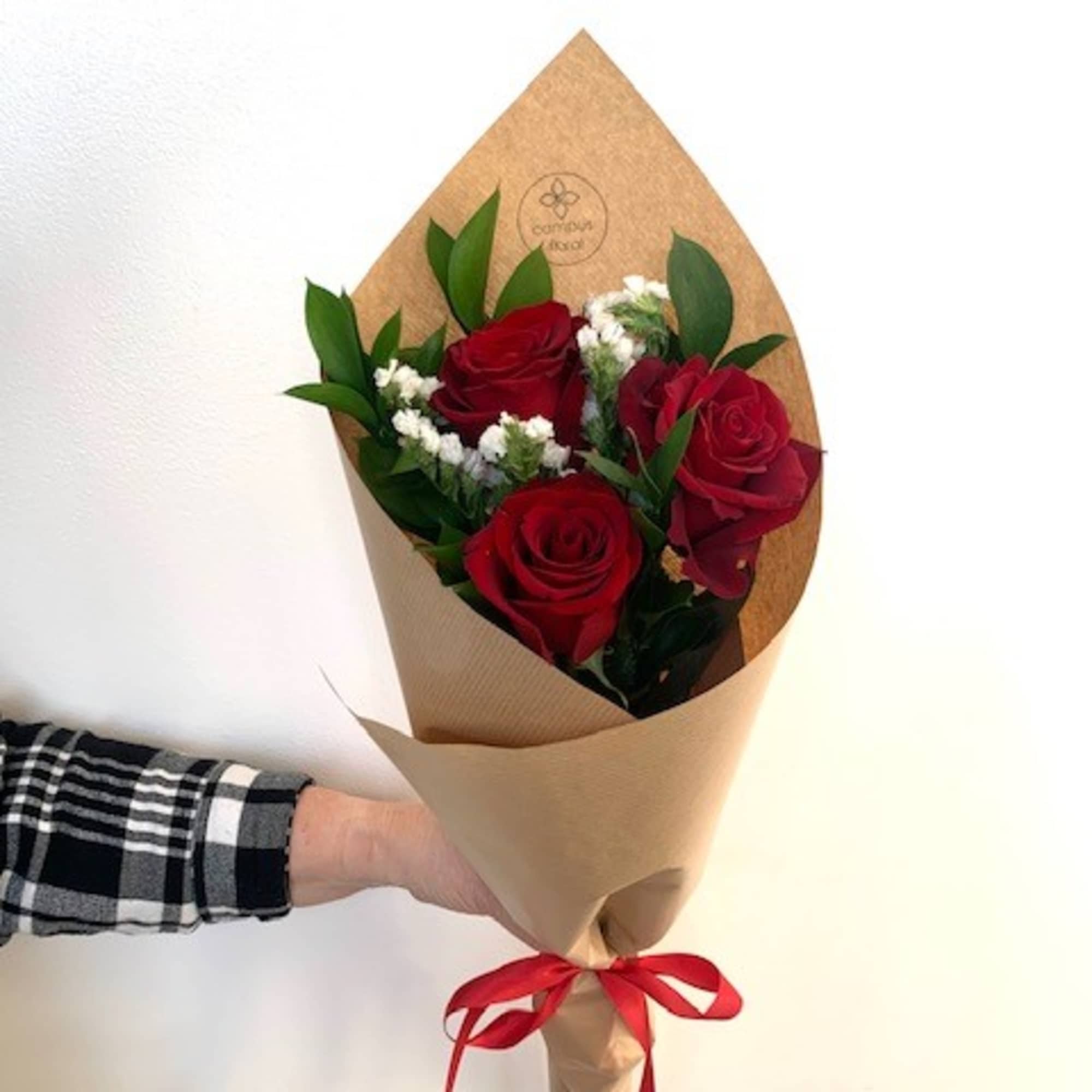 3 roses beautifully arranged, wrapped and tied with a ribbon to add