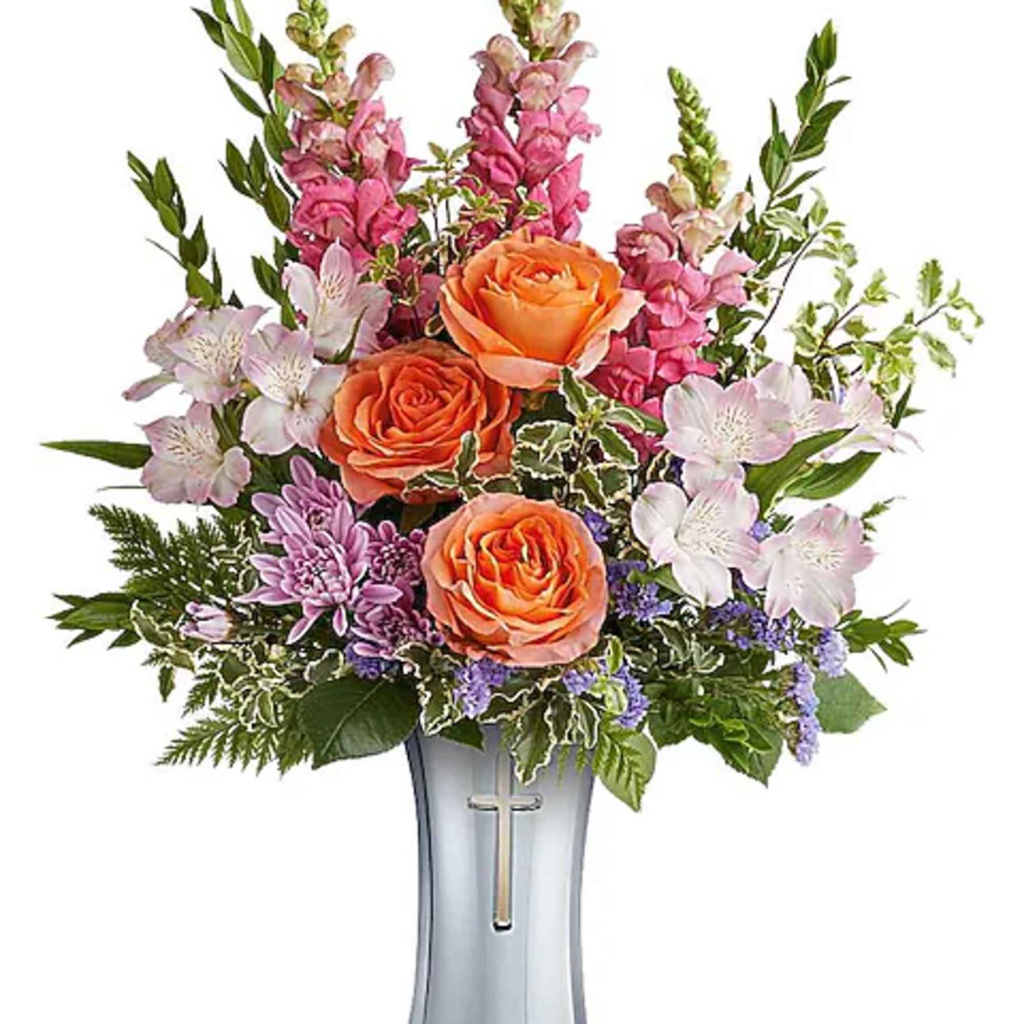 Orange roses and pink mixed flowers in a silver vase with a cross