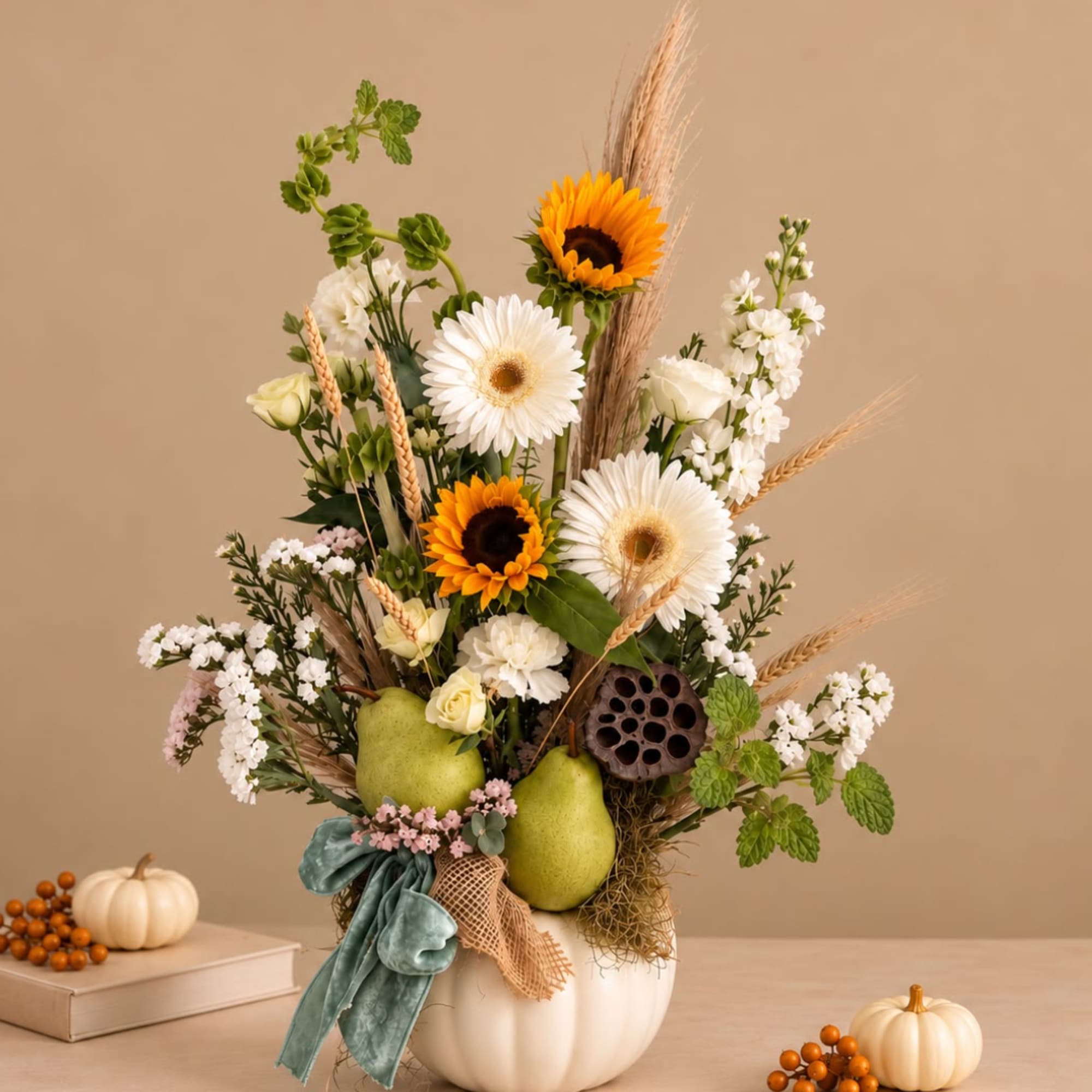 Autumn floral arrangement in a white pumpkin vase with sunflowers and white blooms