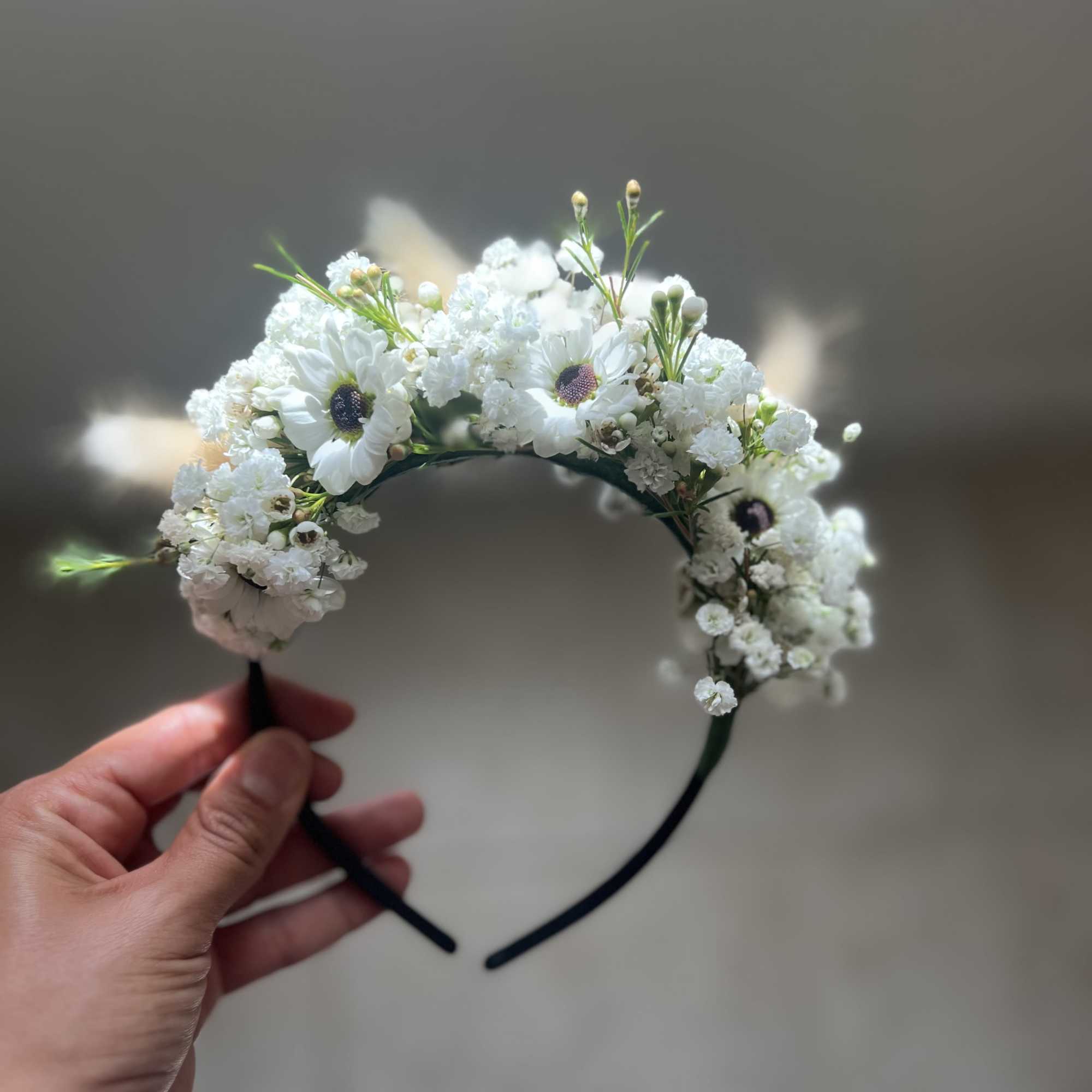 White floral headband with daisy-like blooms and small filler flowers
