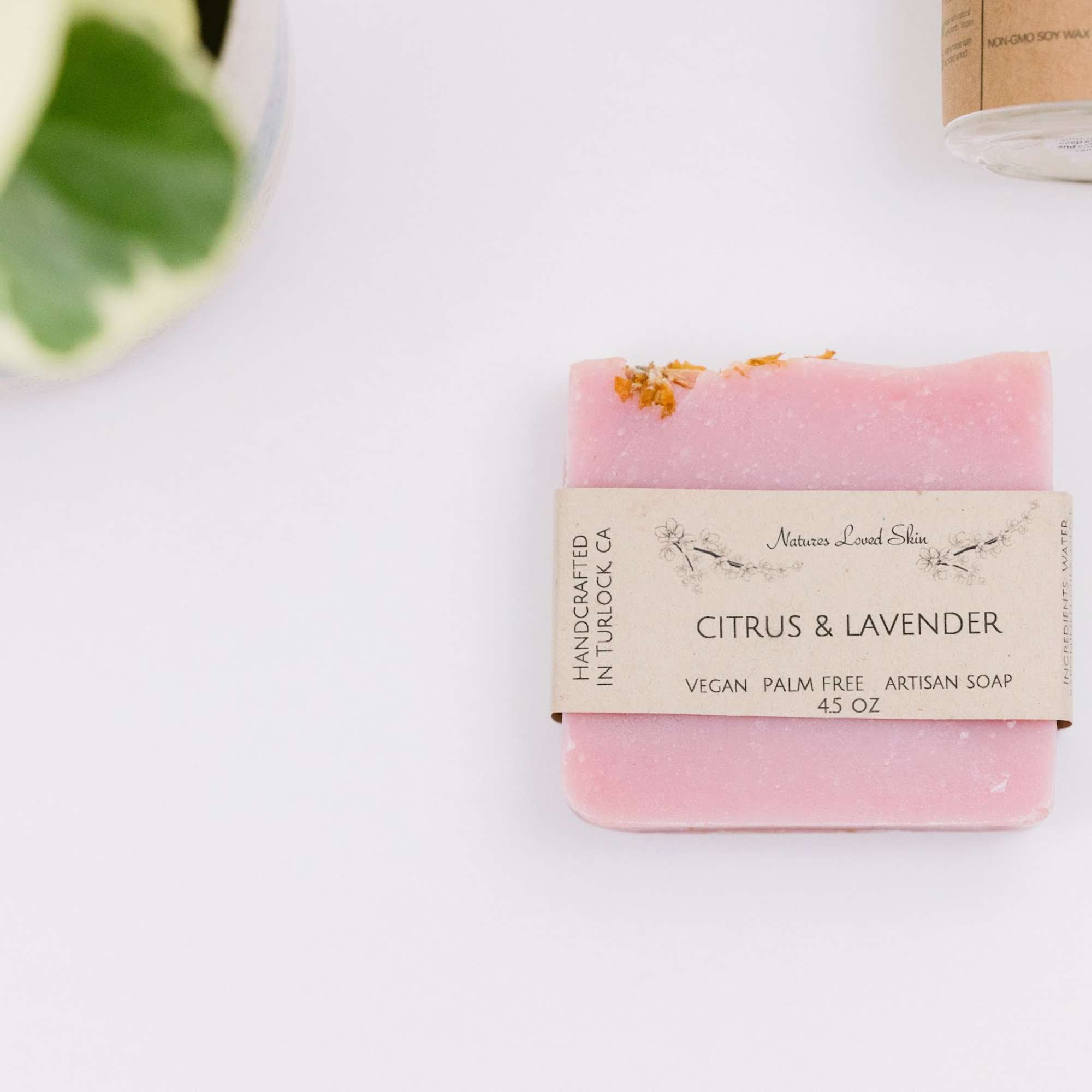 Pink citrus and lavender soap bar with a paper label
