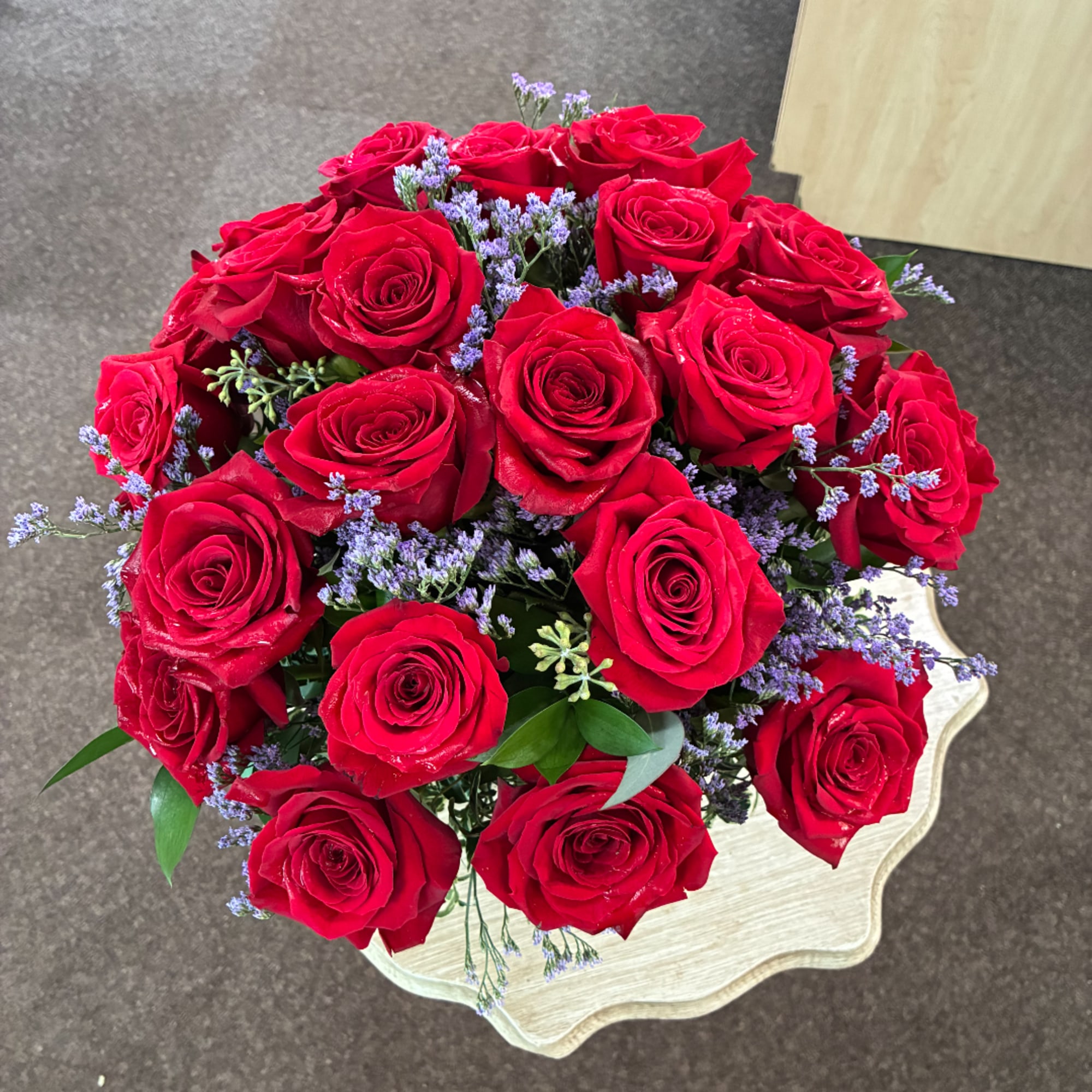 Bouquet of red roses with small purple filler flowers