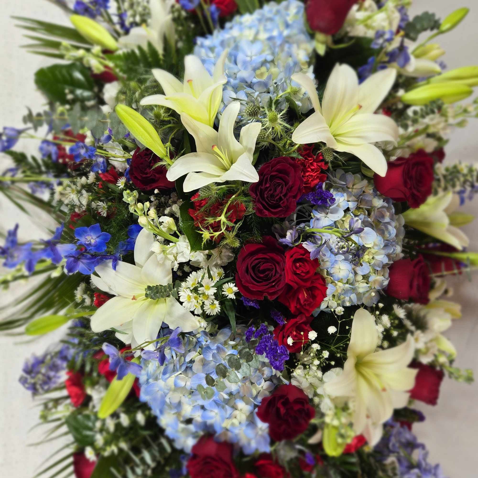 Large bouquet of red roses, white lilies, and blue hydrangeas, photo 3 of 4