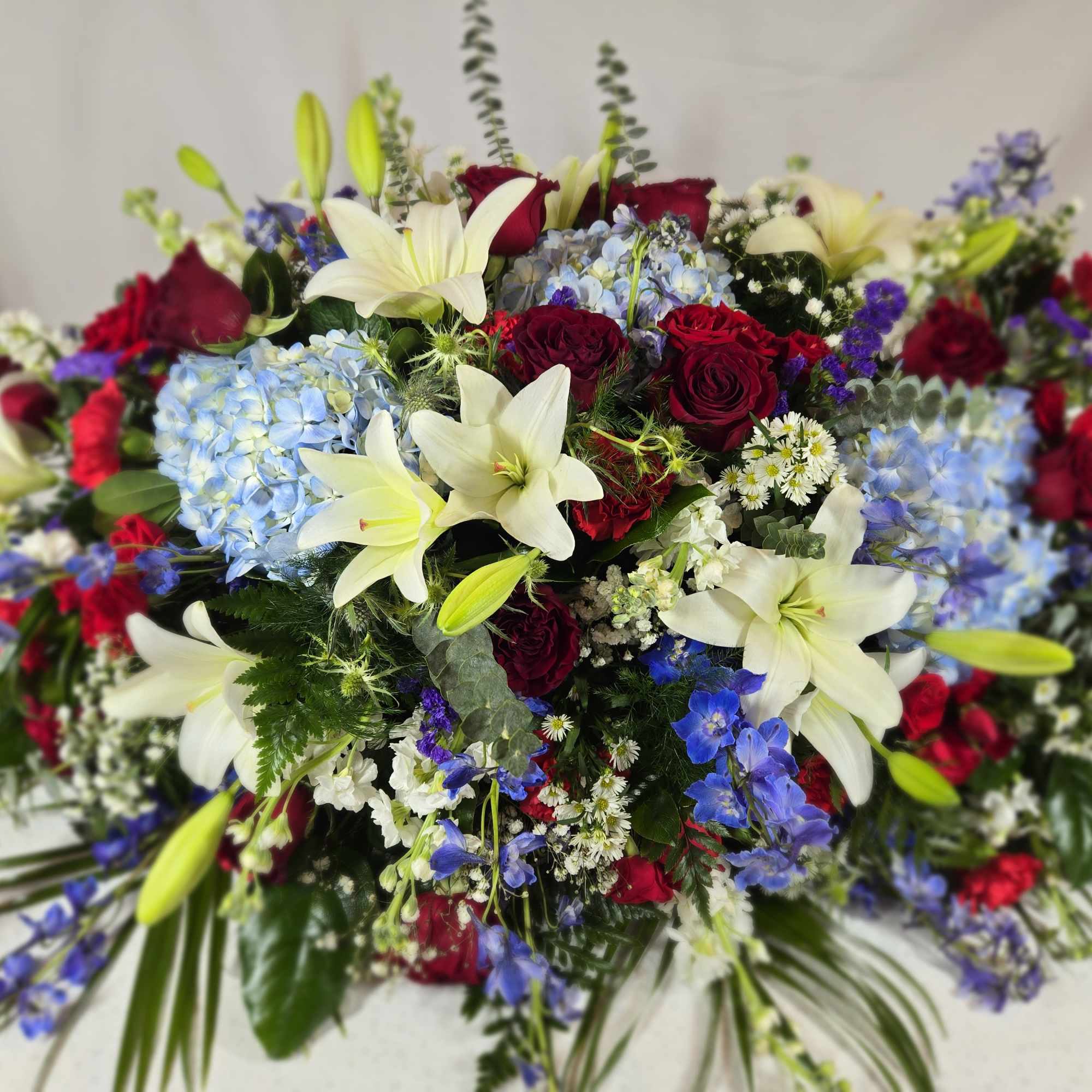 Large bouquet of red roses, white lilies, and blue hydrangeas, photo 4 of 4