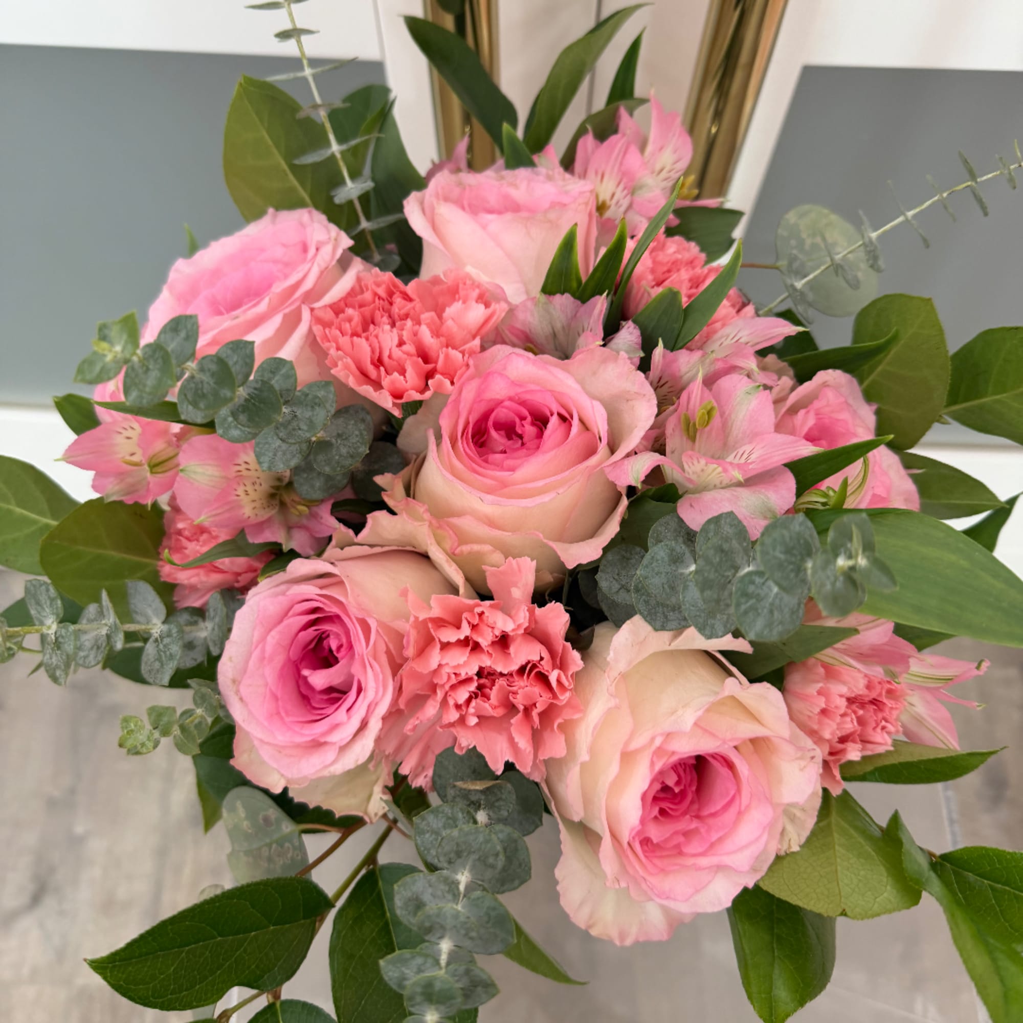 Pink roses and carnations arranged with alstroemeria in a bouquet